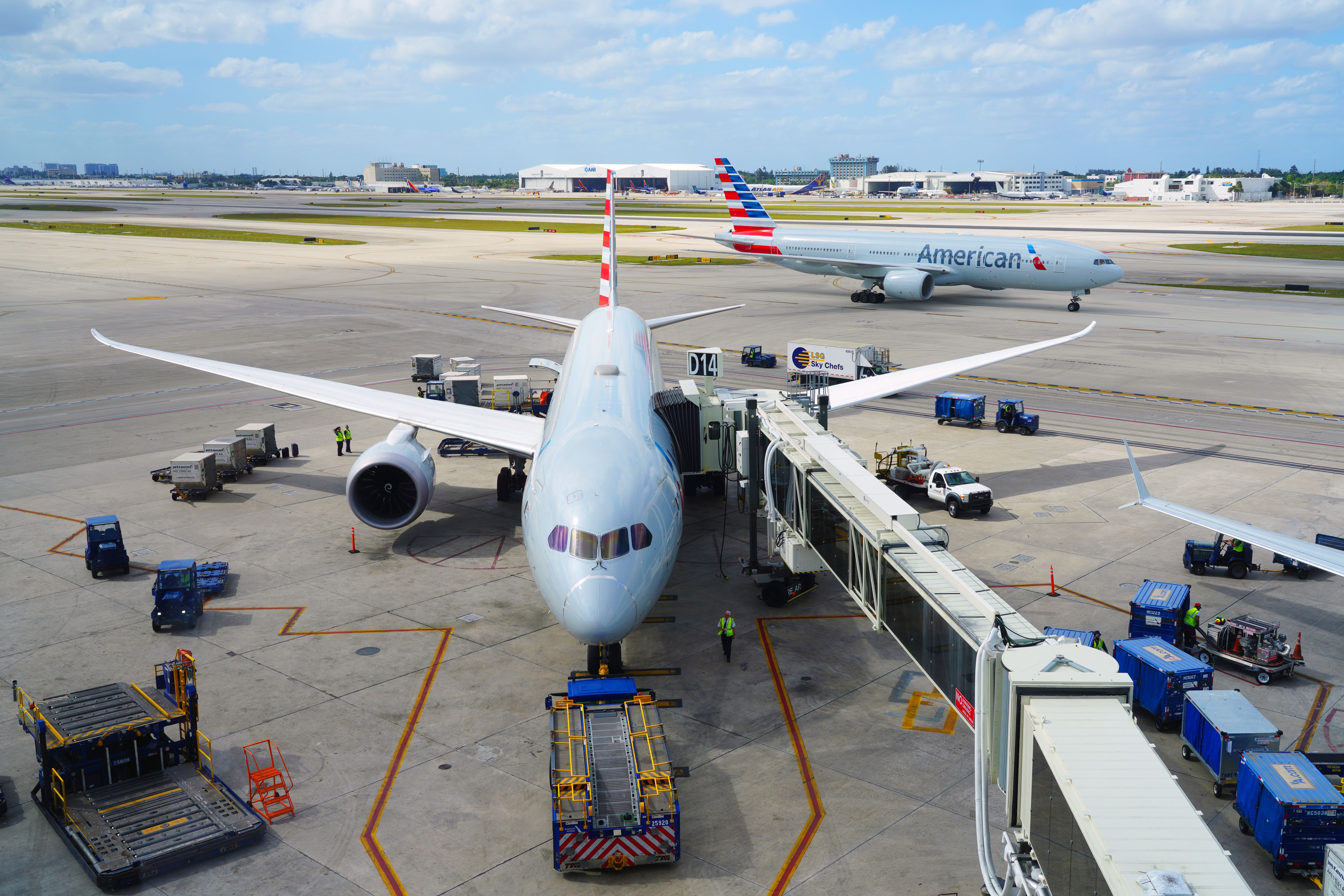 American Airlines Boeing 787 Dreamliner at the gate and Boeing 777-223/ER in the background at Miami International Airport.
