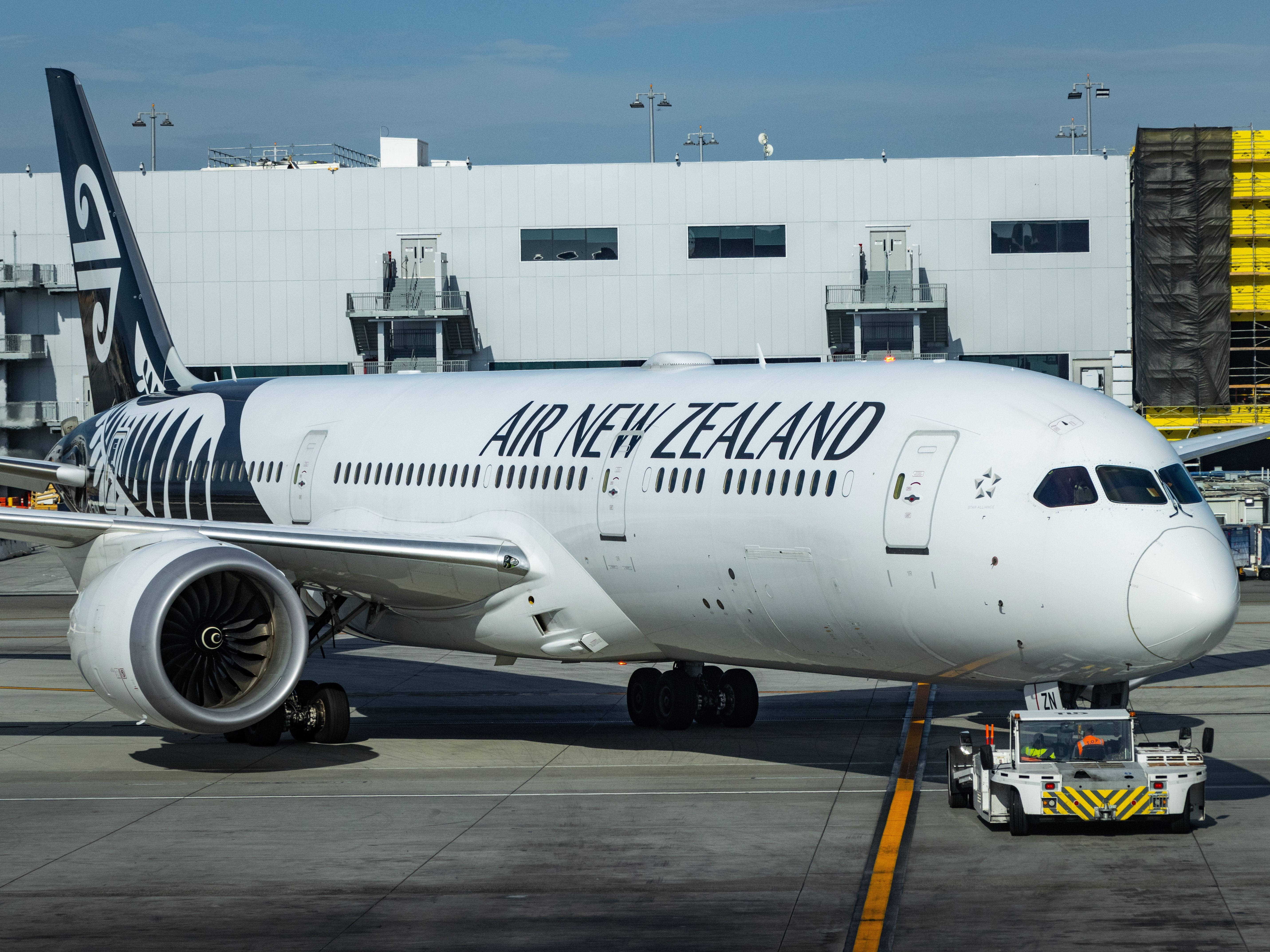 An Air New Zealand Boeing 787 Being Pushed Back on an airport apron.