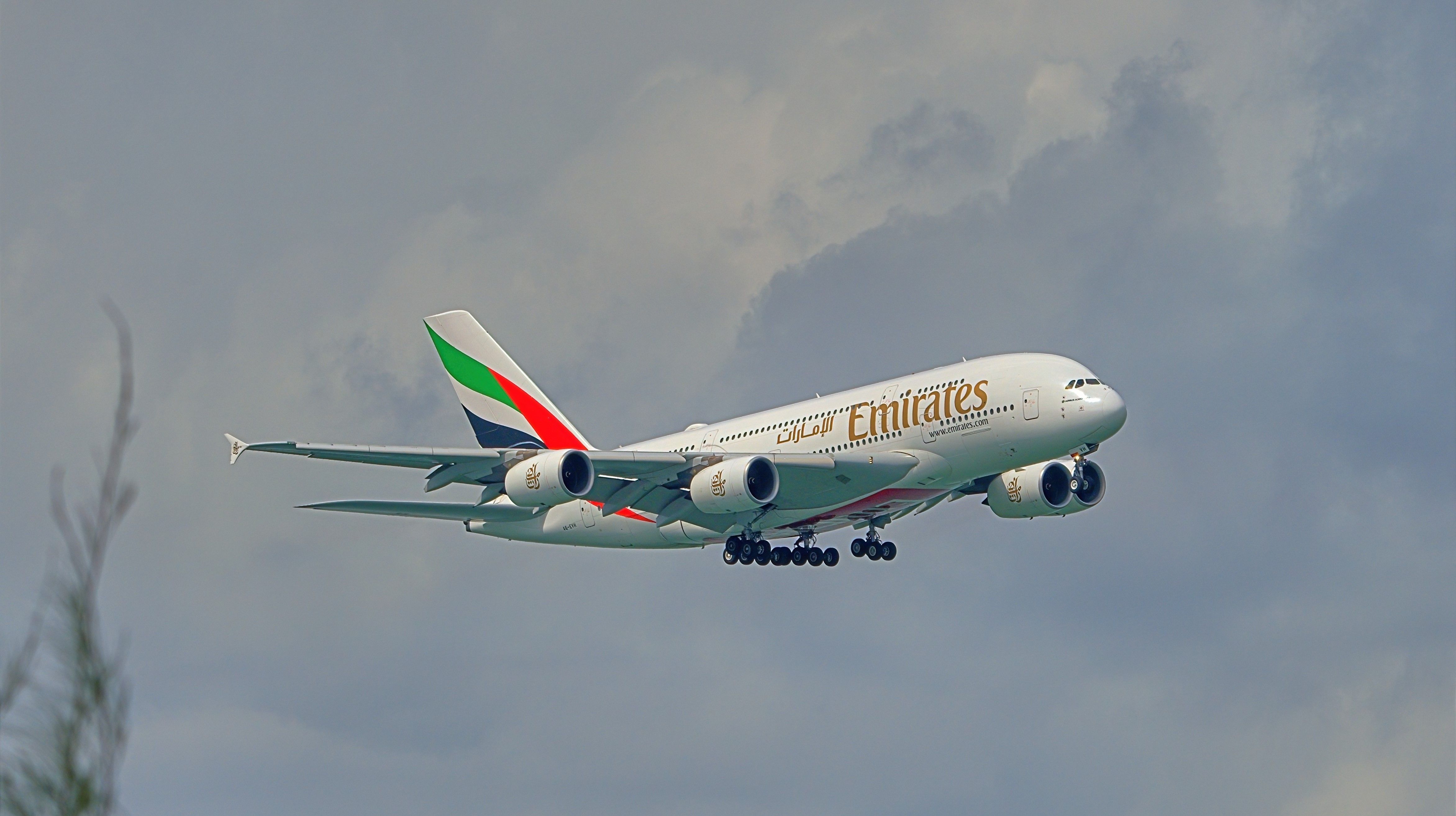 An Emirates Airbus A380 flying in the sky.