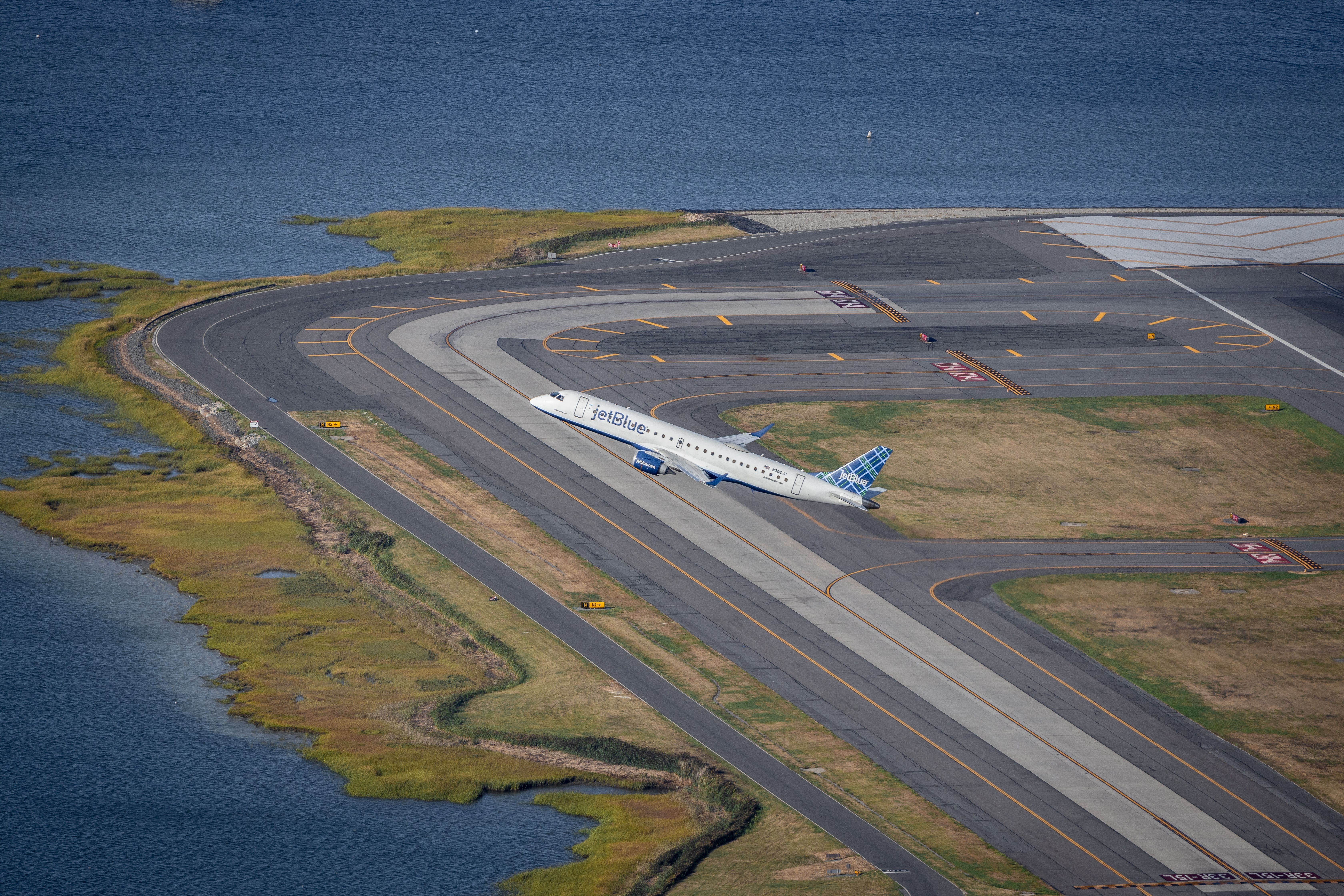 An aerial shot of a JetBlue Airways Embraer 190 taking off in Boston