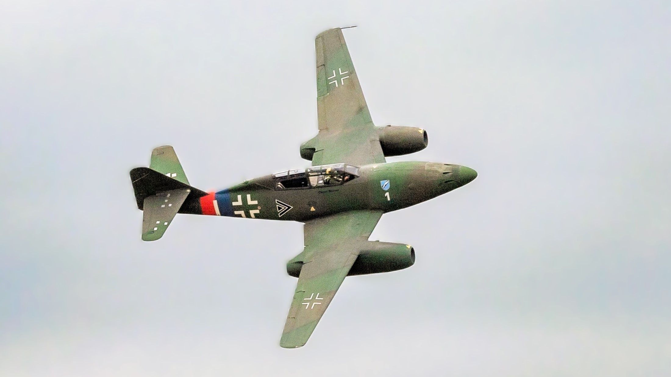 A Messerschmitt ME-262 flying in the sky.