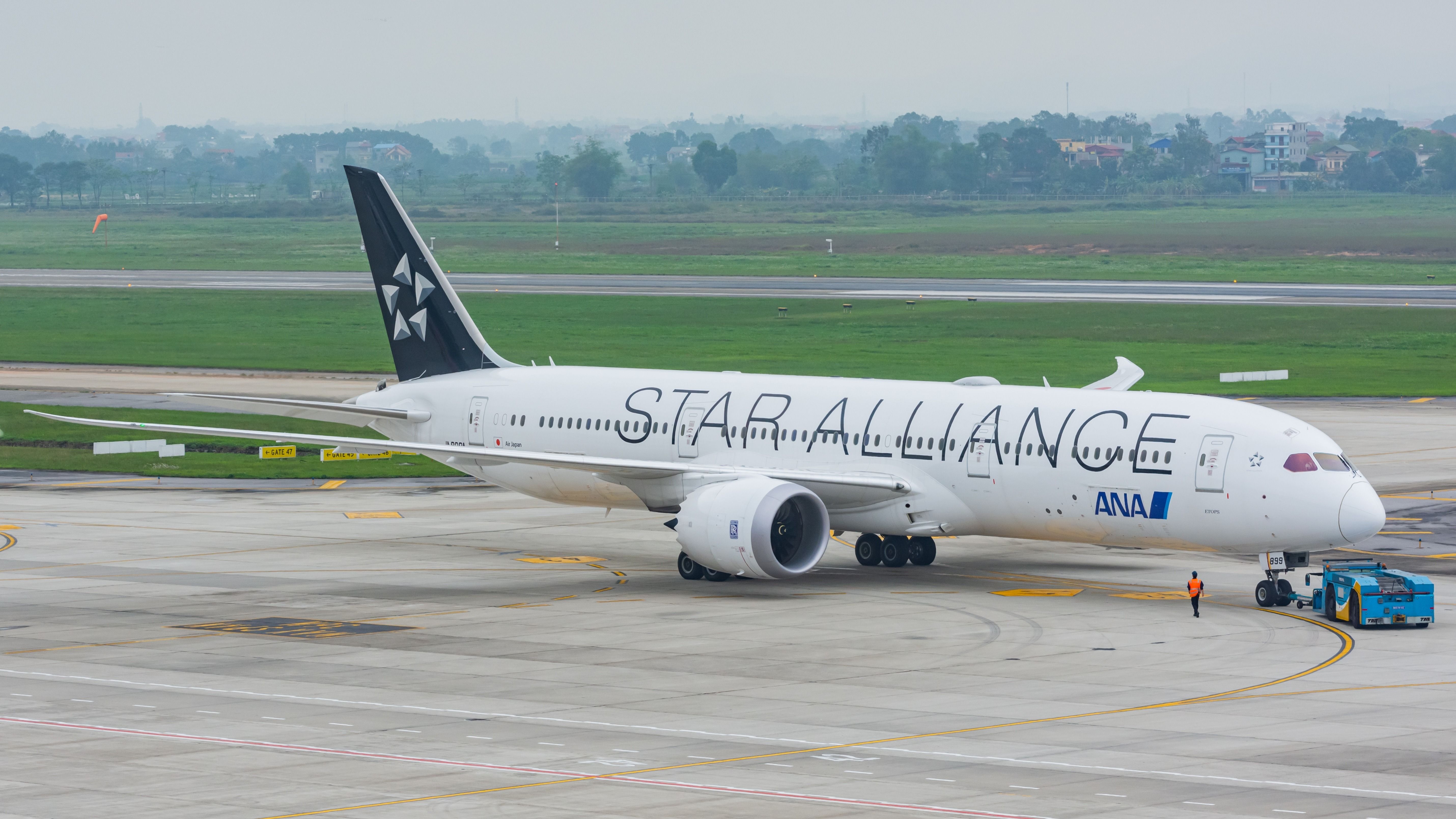 An All Nippon Airways ANA in Star Alliance livery being pushed back at Noi Bai International Airport.