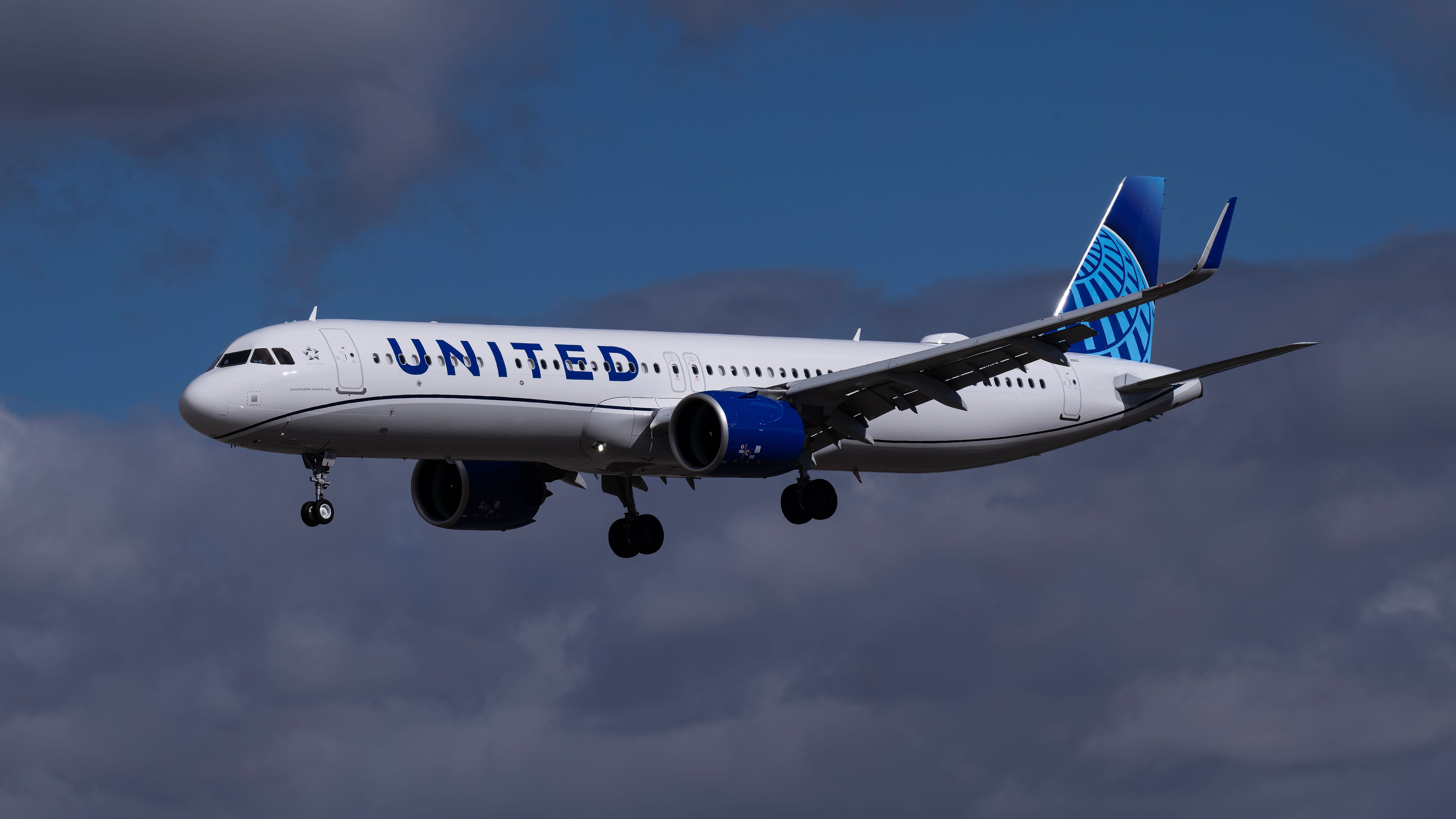 A United Airlines Airbus A321neo flying in the sky.