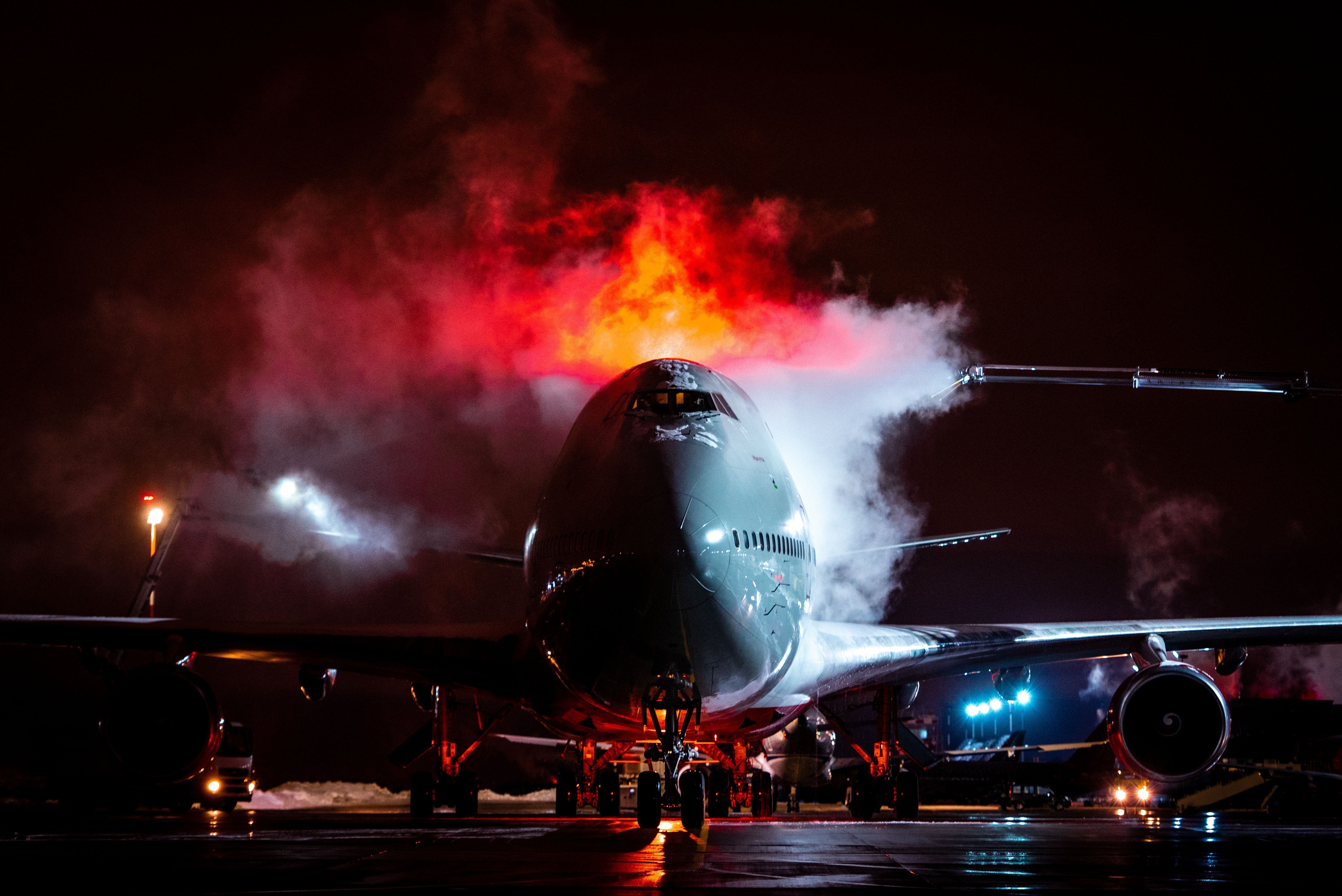 A Boeing 747-400 Being De-iced At Night.