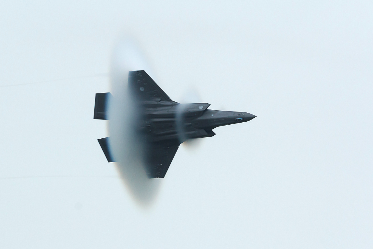 A Lockheed Martin F-35A Lightning II in the sky causing a sonic boom. 