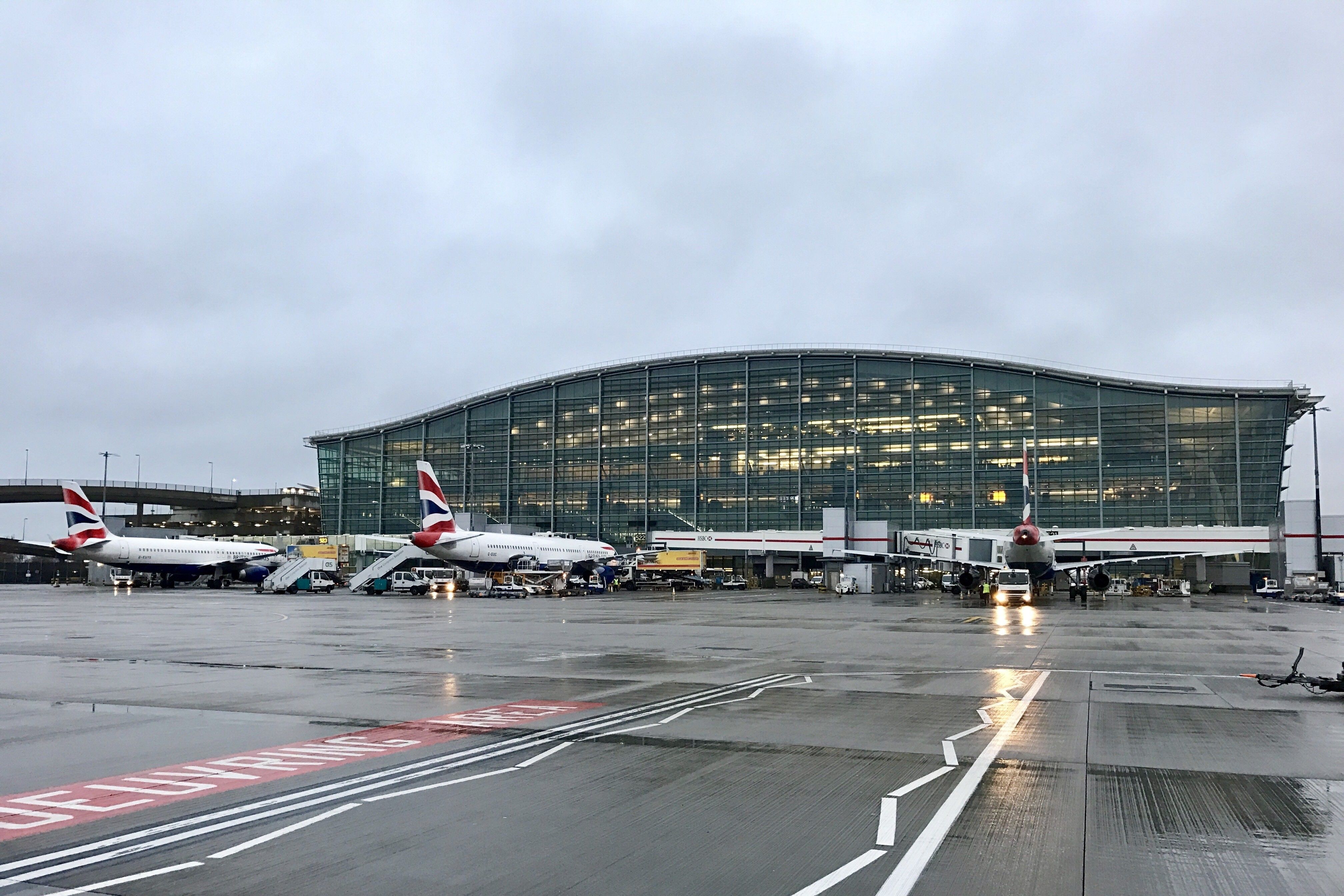 Two British Airways aircraft parked at gates at London Heathrow Airport Terminal 5.