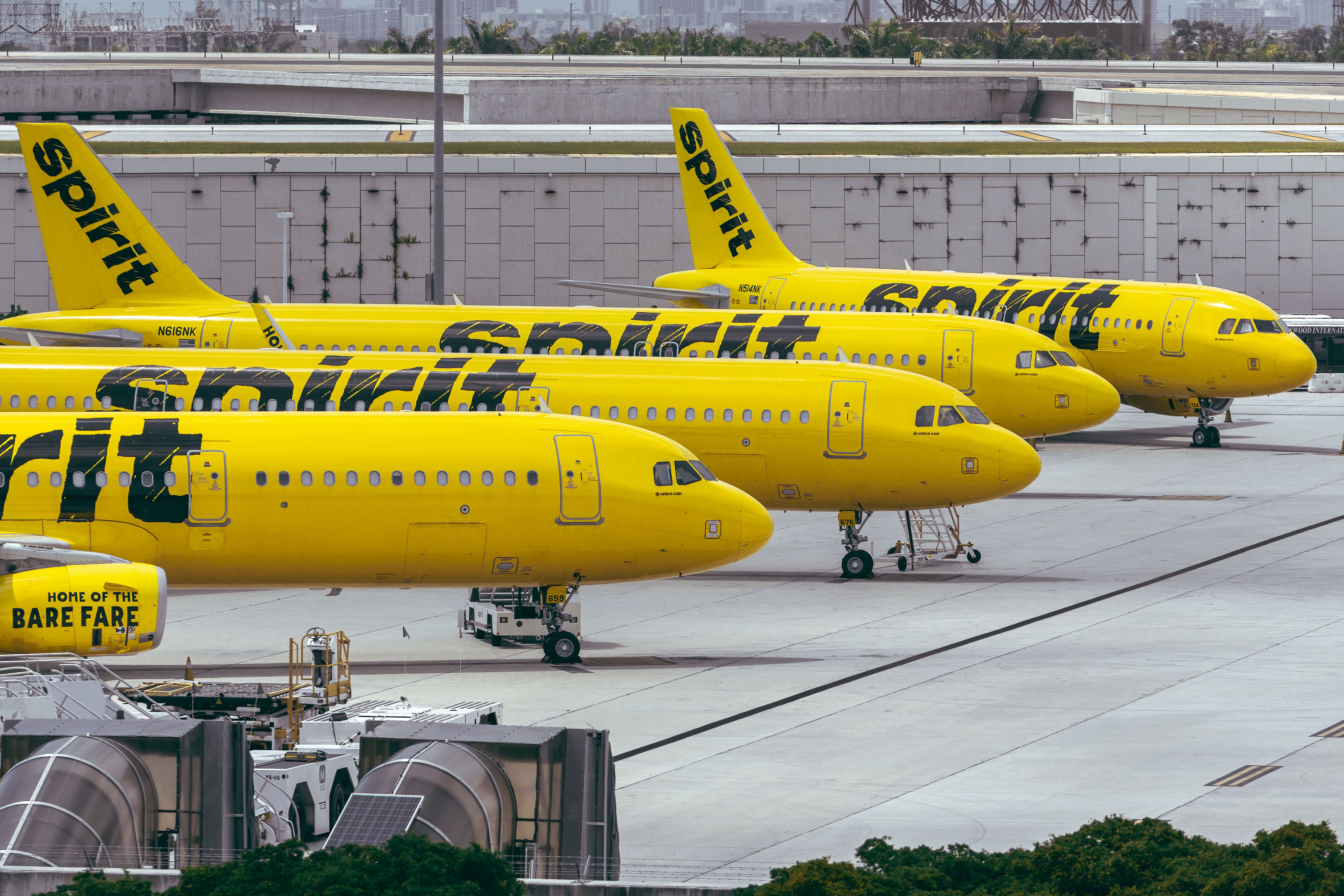 Several Spirit Airlines aircraft parked on the apron at Fort Lauderdale Hollywood International Airport.