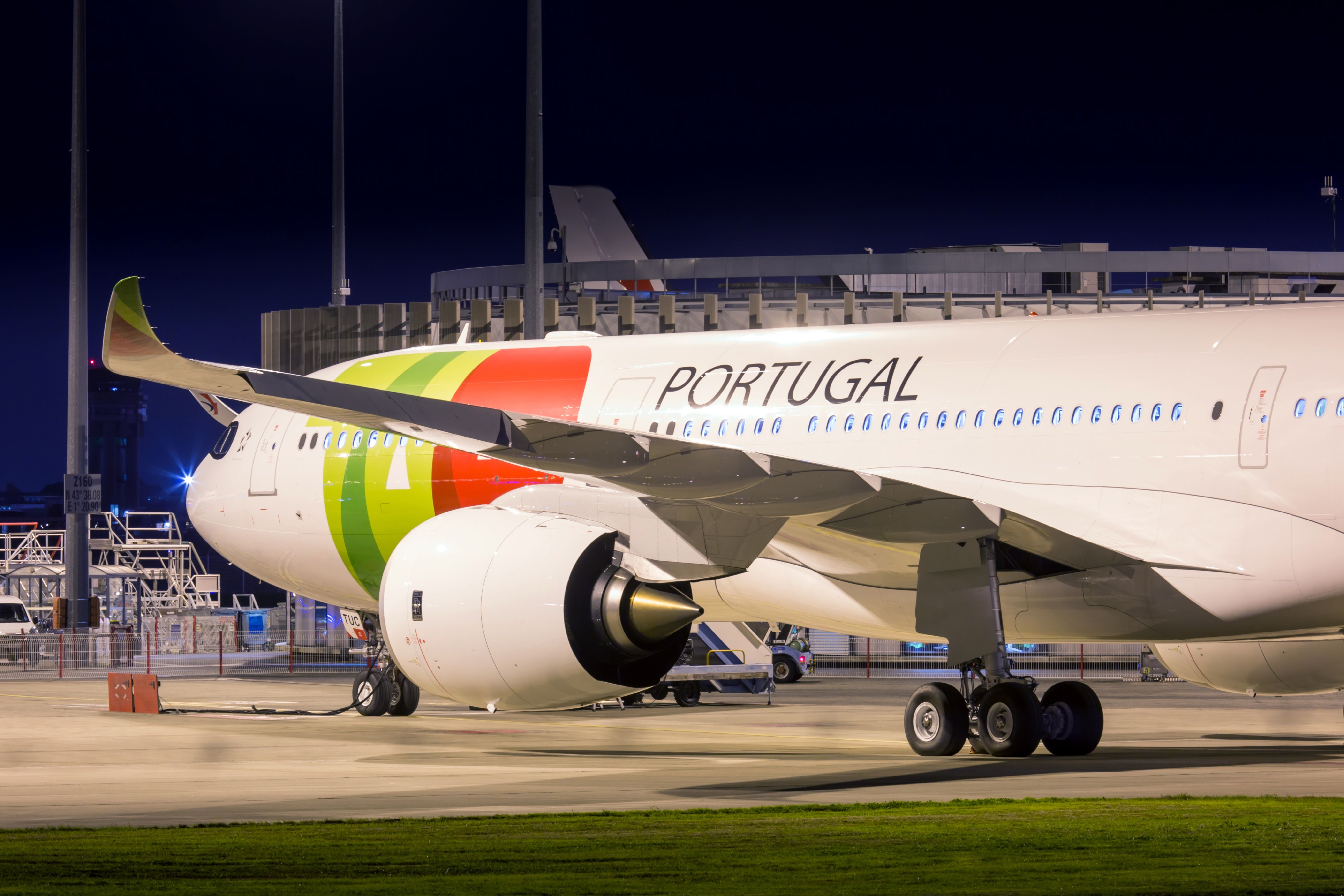 A TAP Air Portugal Airbus A330neo on an airport apron.