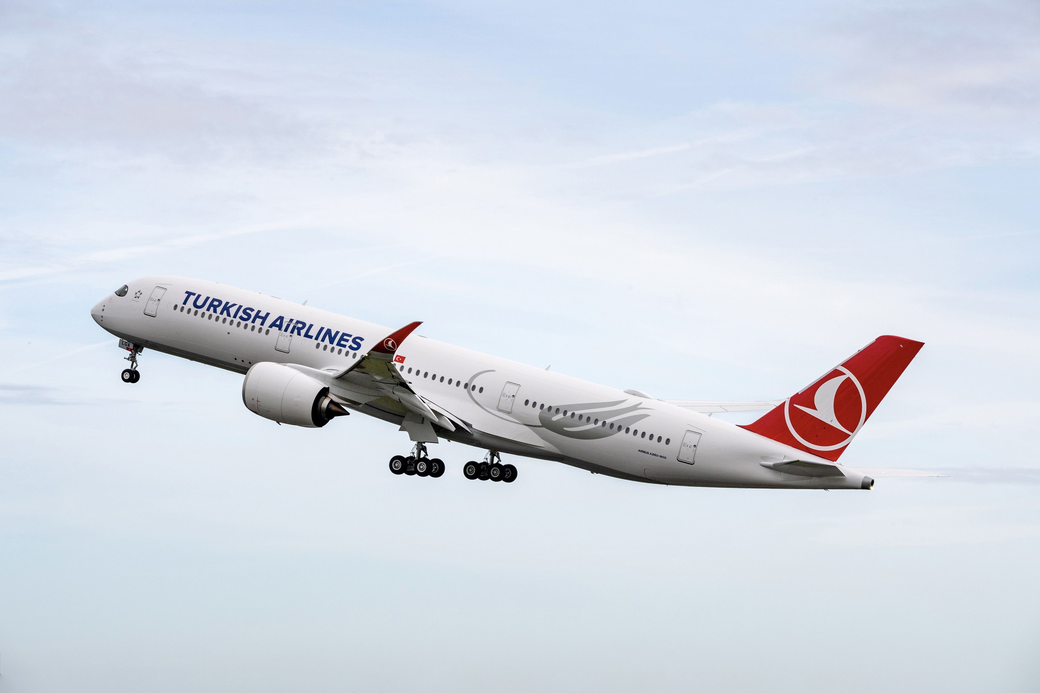 A Turkish Airlines Airbus A350-900 flying in the sky.