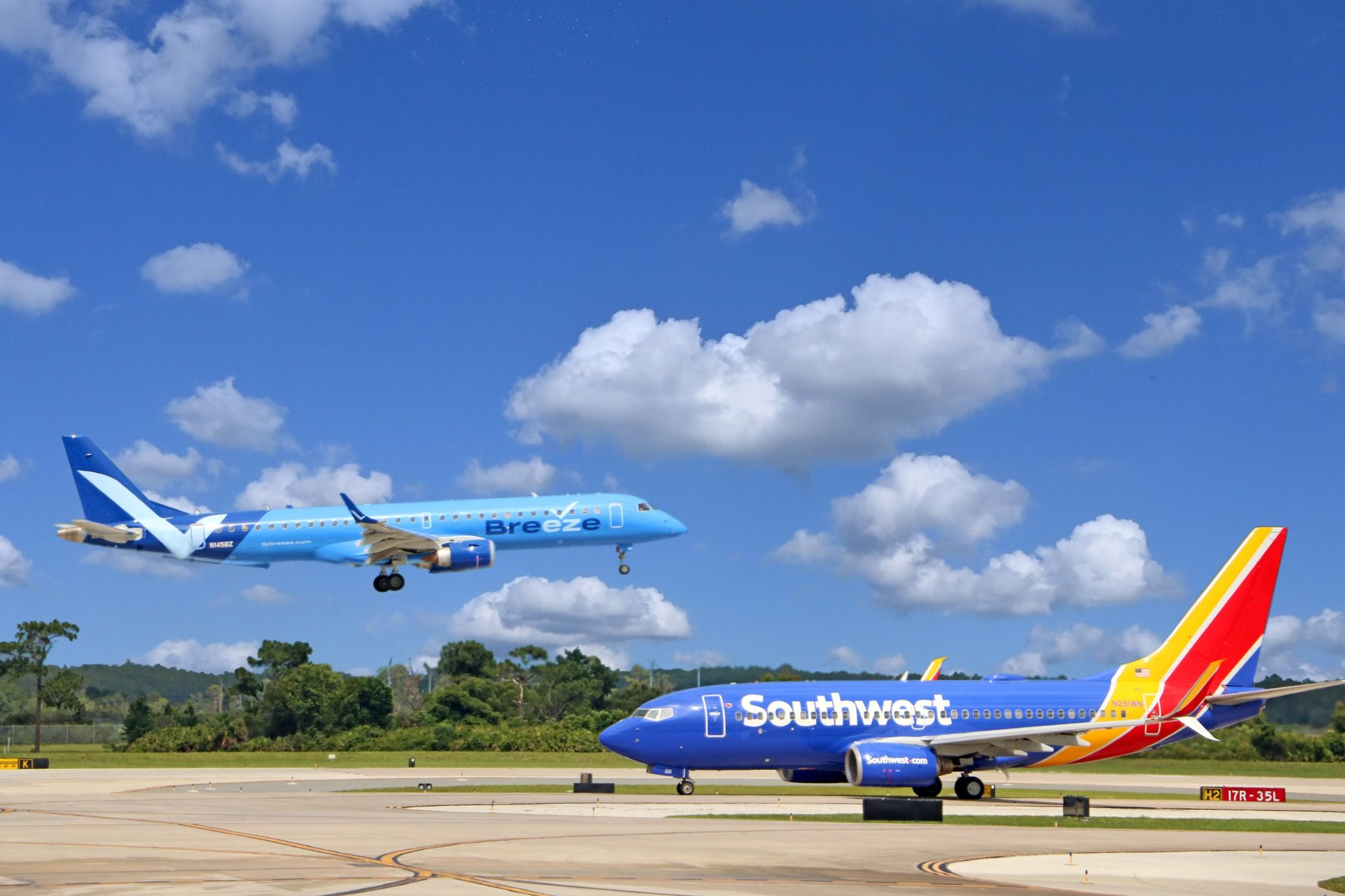 Breeze Airways Embraer E190 and Southwest Airlines Boeing 737-7H4 at Orlando International Airport.