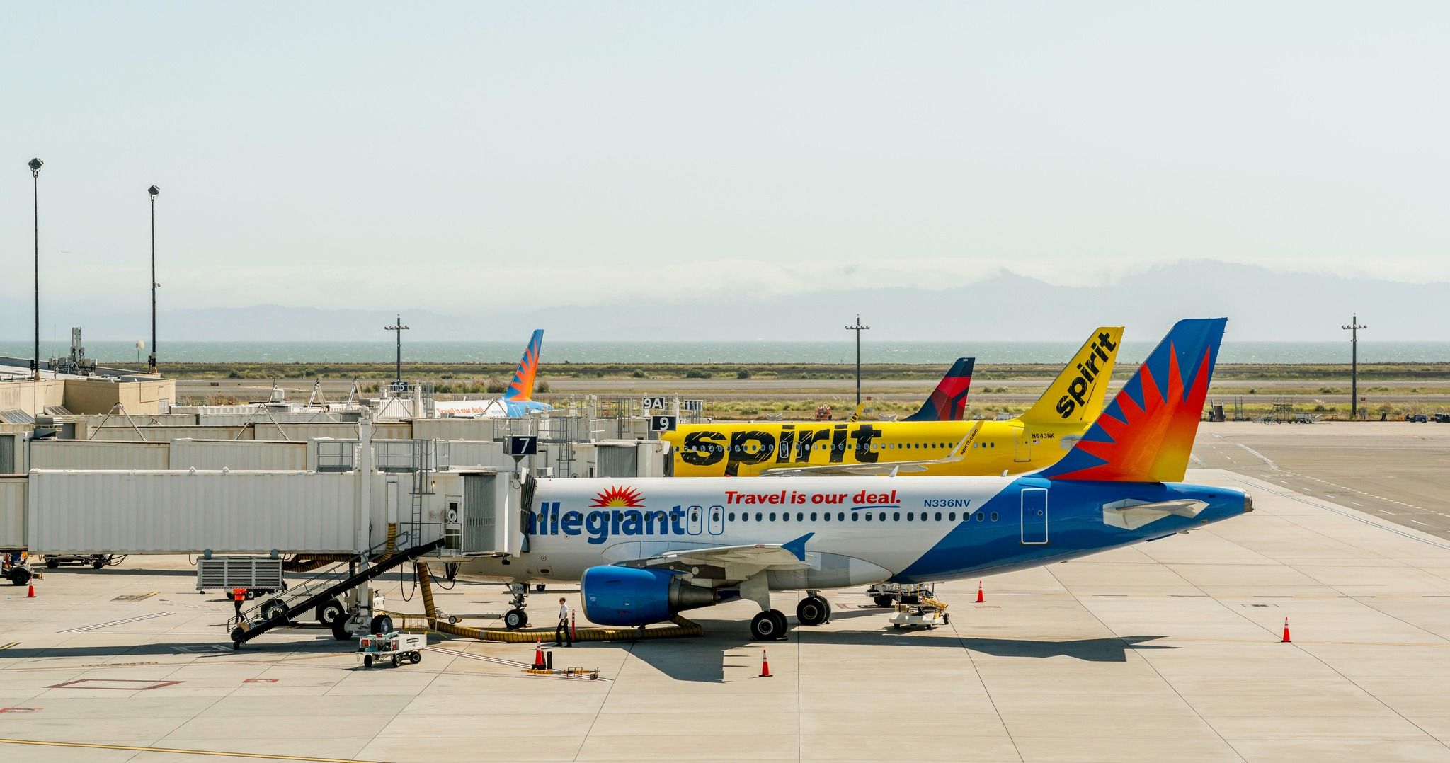 Allegiant Air, Spirit Airlines, and Delta Air Lines aircraft at Metropolitan Oakland International Airport.