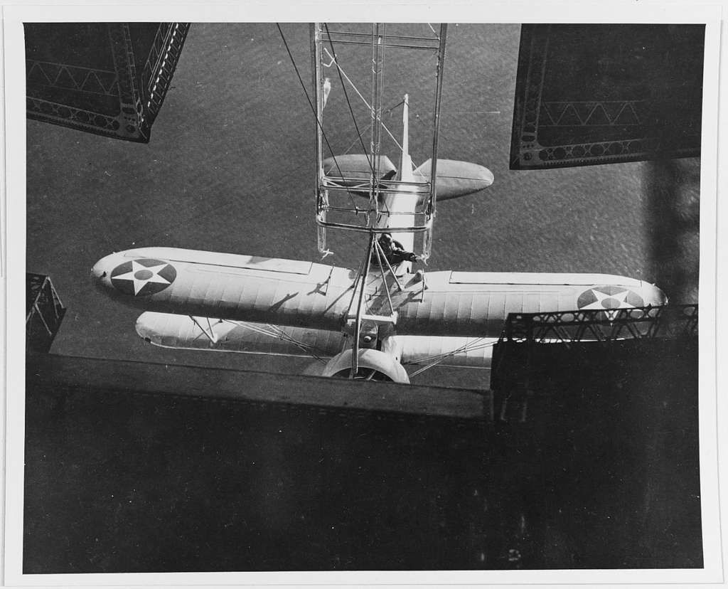 An F9C Sparrowhawk hanging by hooks of the USS Akron.