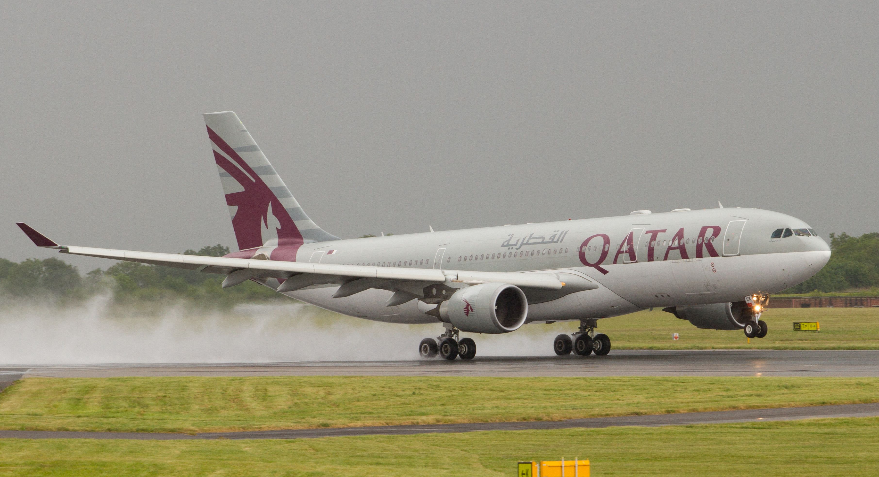 A Qatar Airways Airbus A330-200 on the apron at Manchester Airport In Wet Conditions.