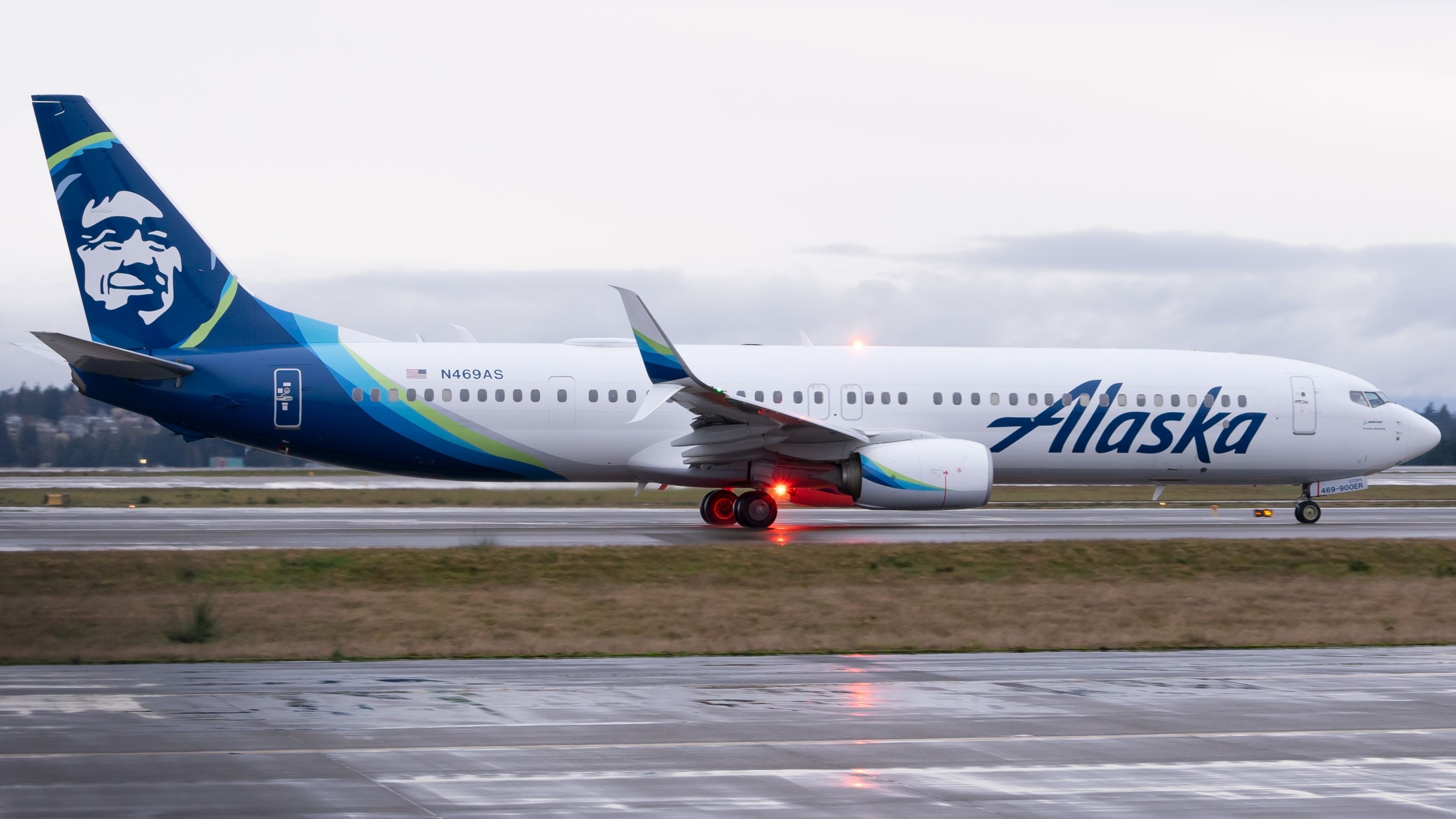 An Alaska Airlines Boeing 737-900ER on an airport apron.