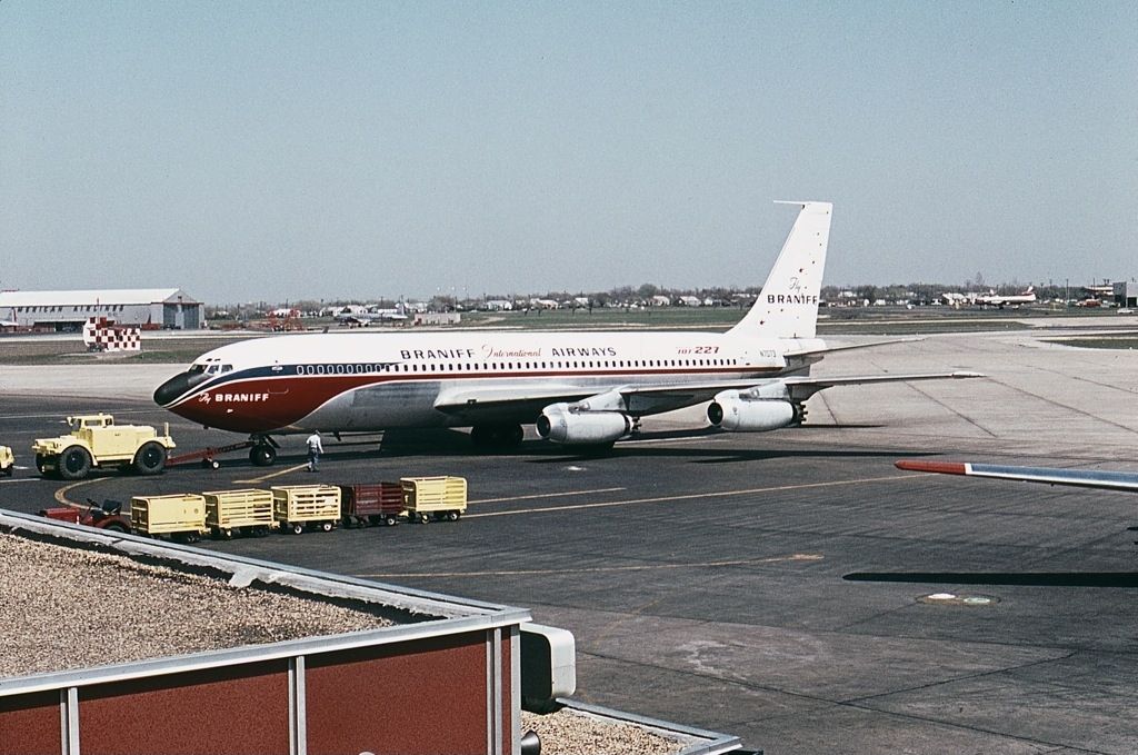 A Braniff International Airways Boeing 707-200 on an airport apron.