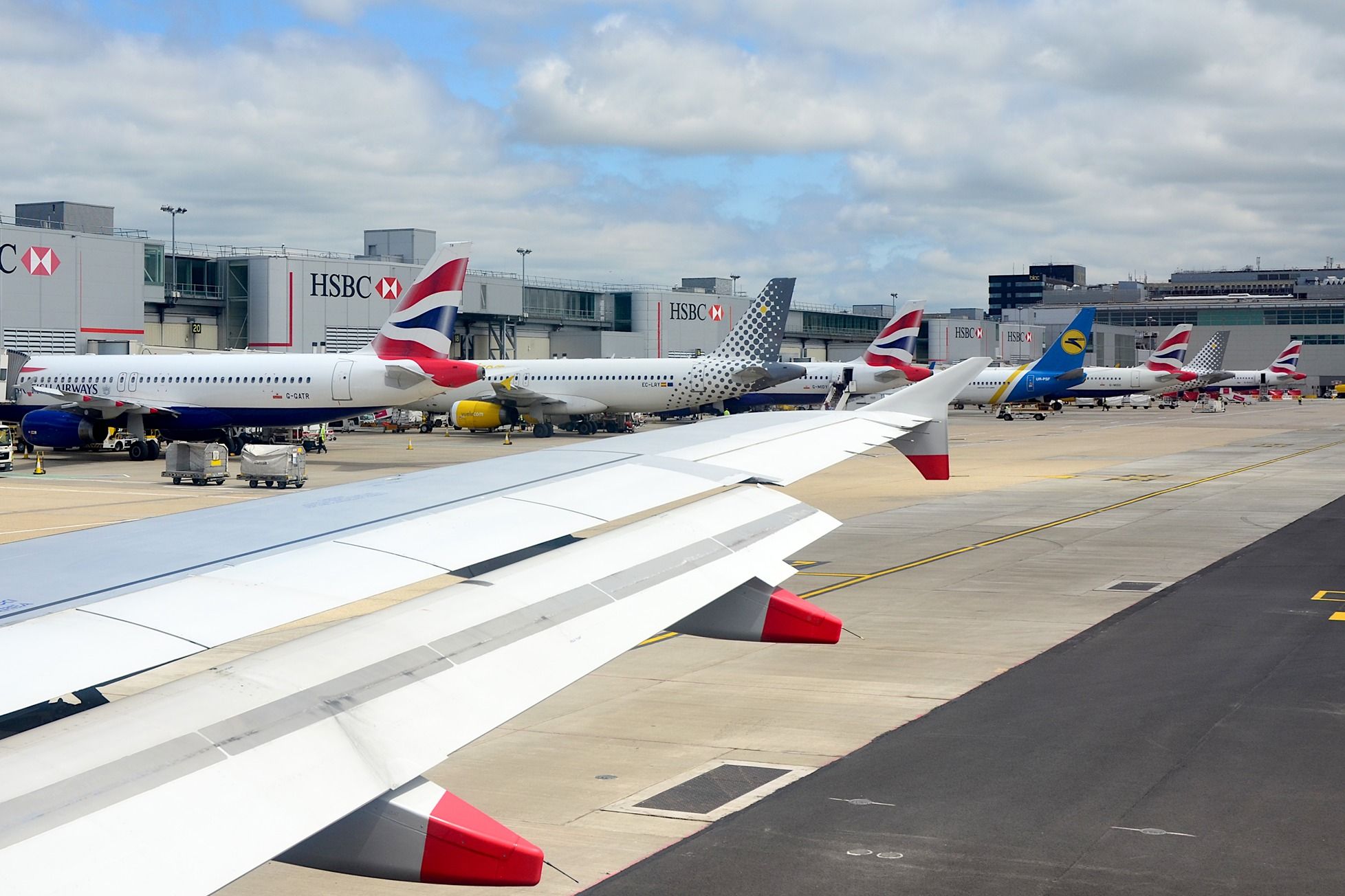 British Airways, Volotea, and Ukrainian International Airlines aircraft at London Gatwick Airport LGW shutterstock_1763997245