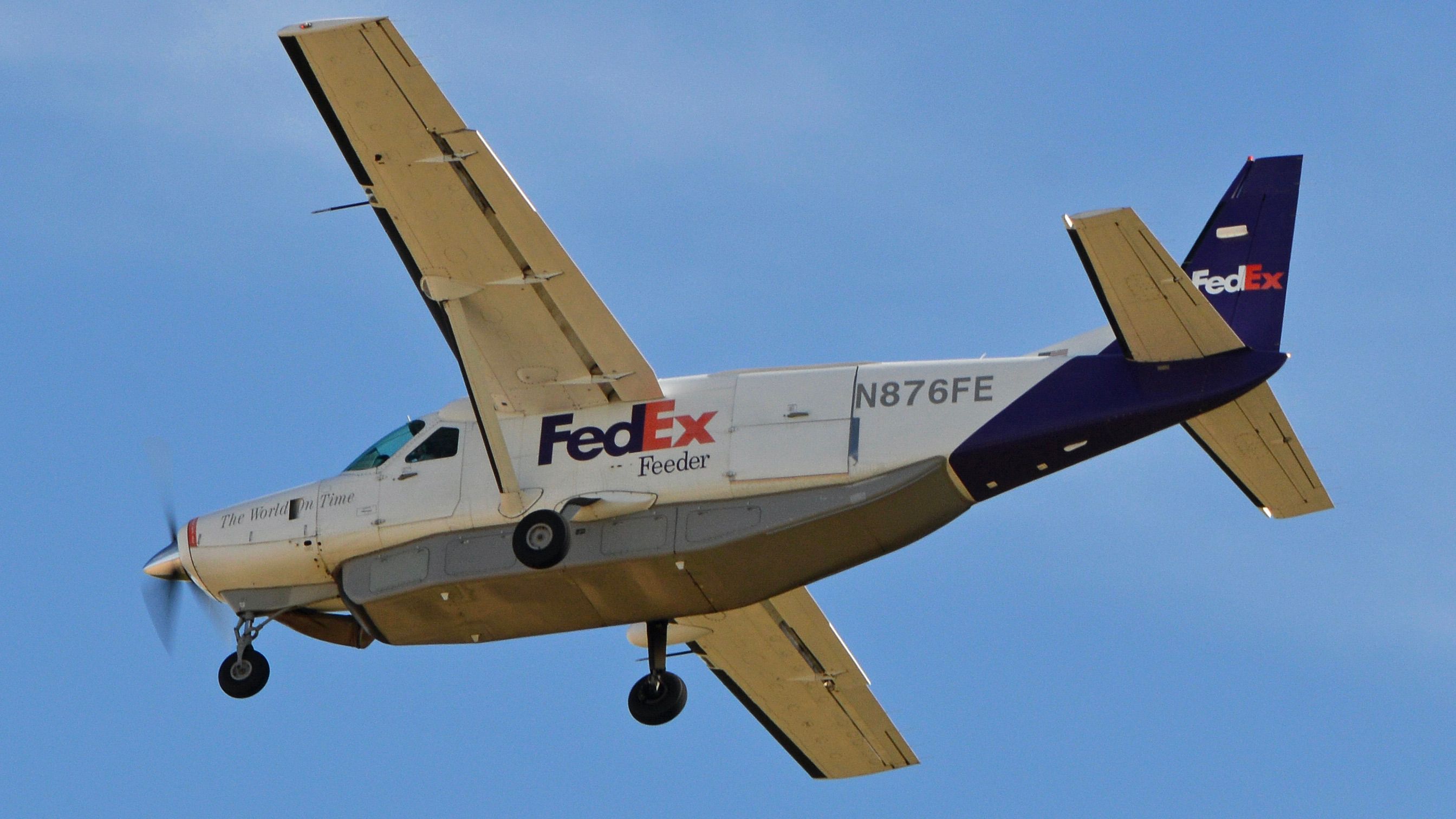 A FedEx Cessna 208B Caravan flying in the sky.