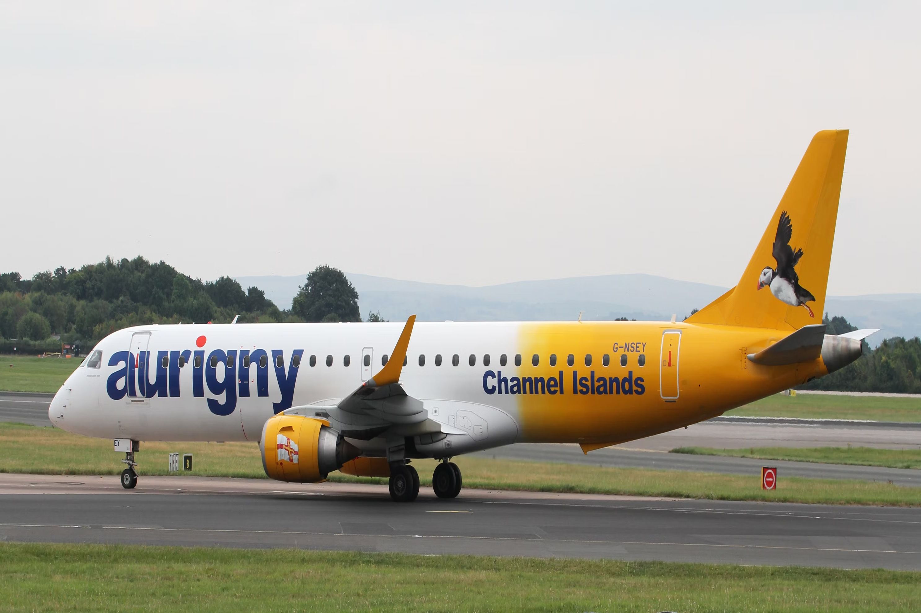 Aurigny Air Services' Embraer ERJ 195 aircraft on the runway.