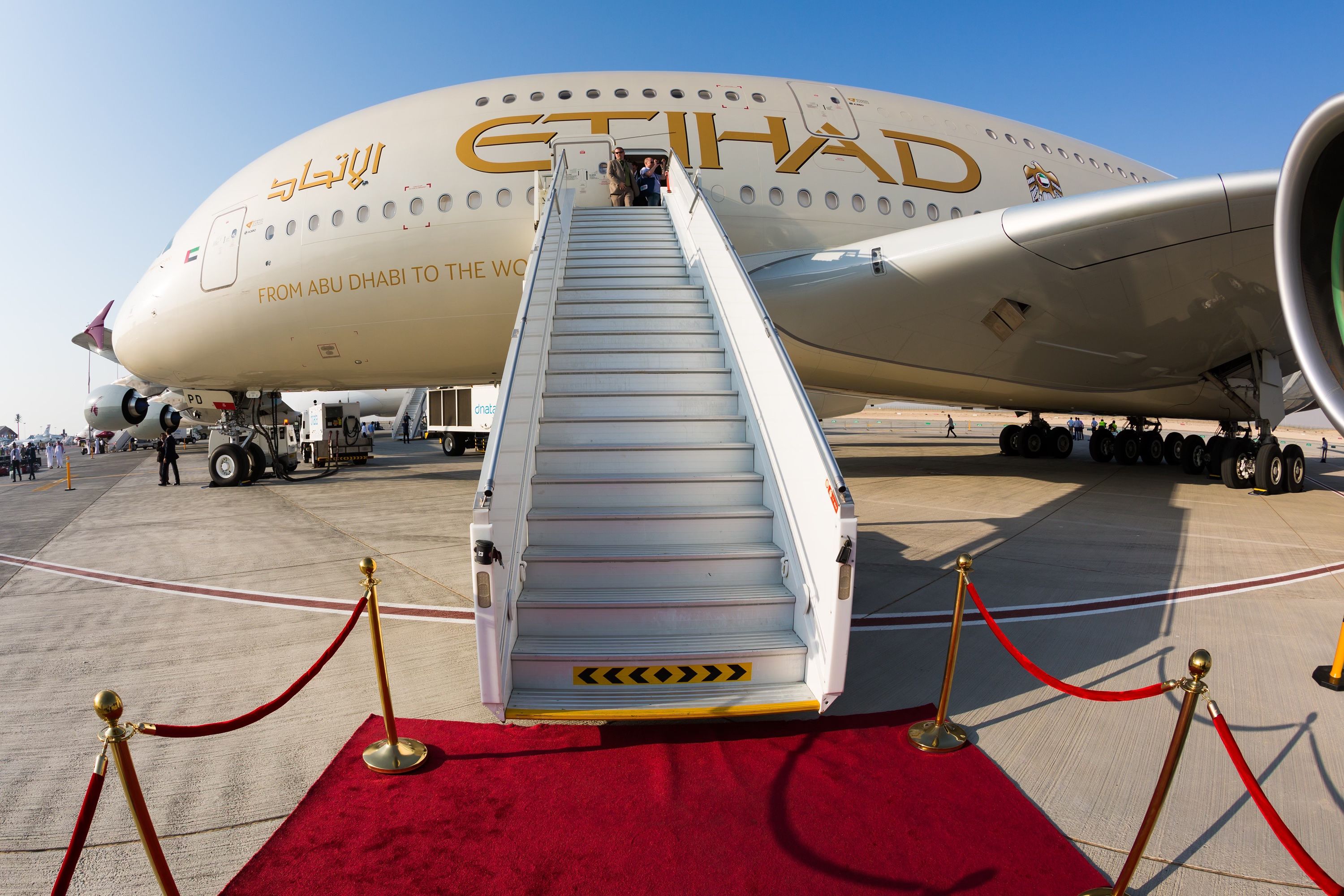 An Etihad Airbus A380 on display with a red carpet laid at the edge of the air stairs.