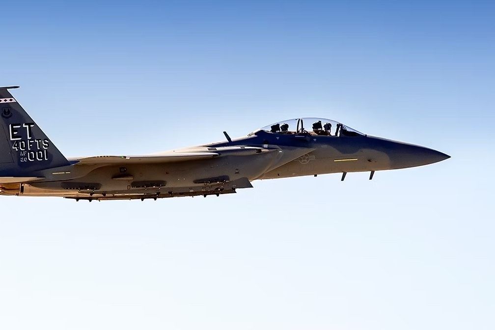 An F-15 flying in the sky.