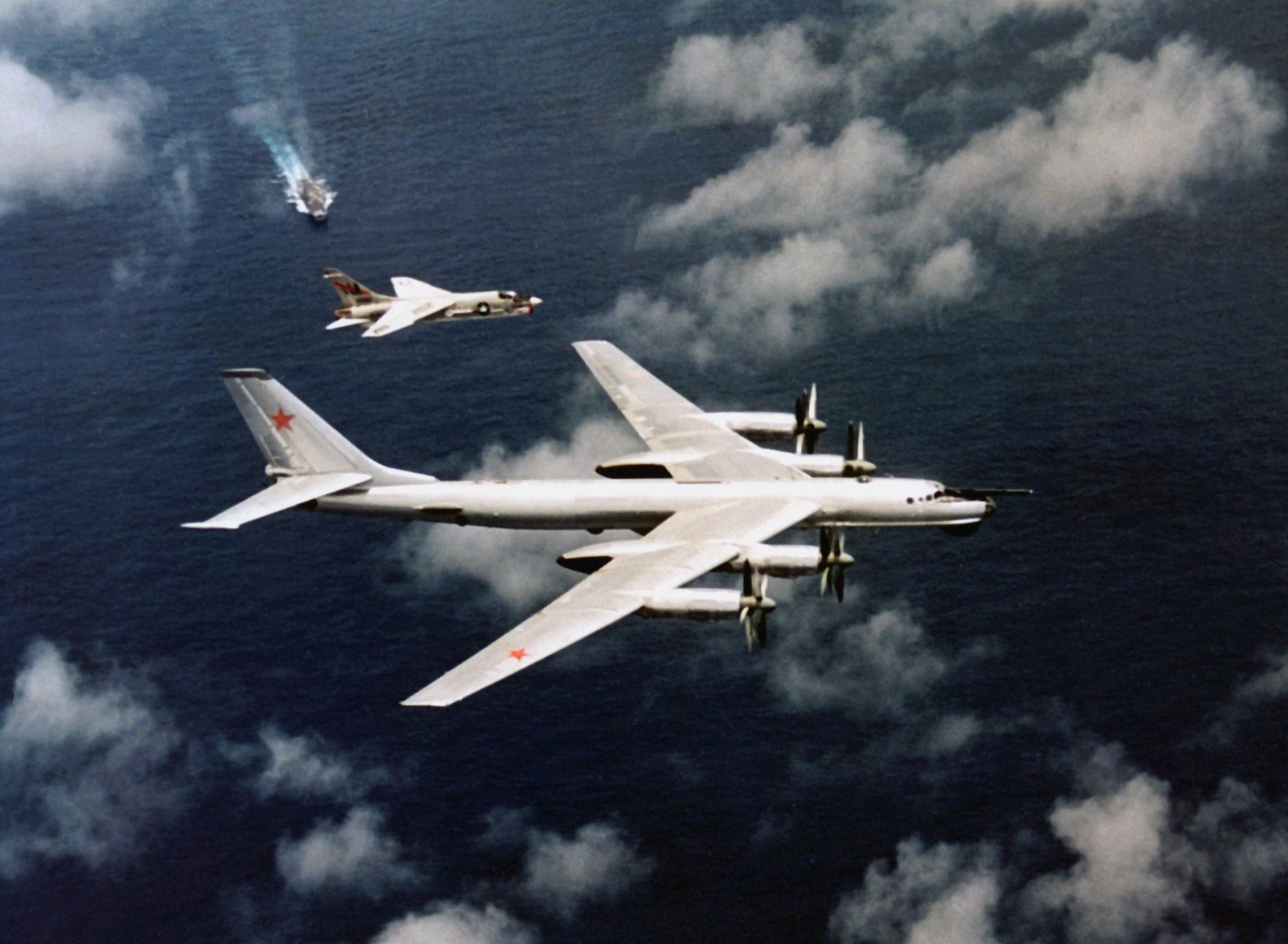 An F-8J Crusader escorting a Soviet Tu-95 over USS Oriskany.