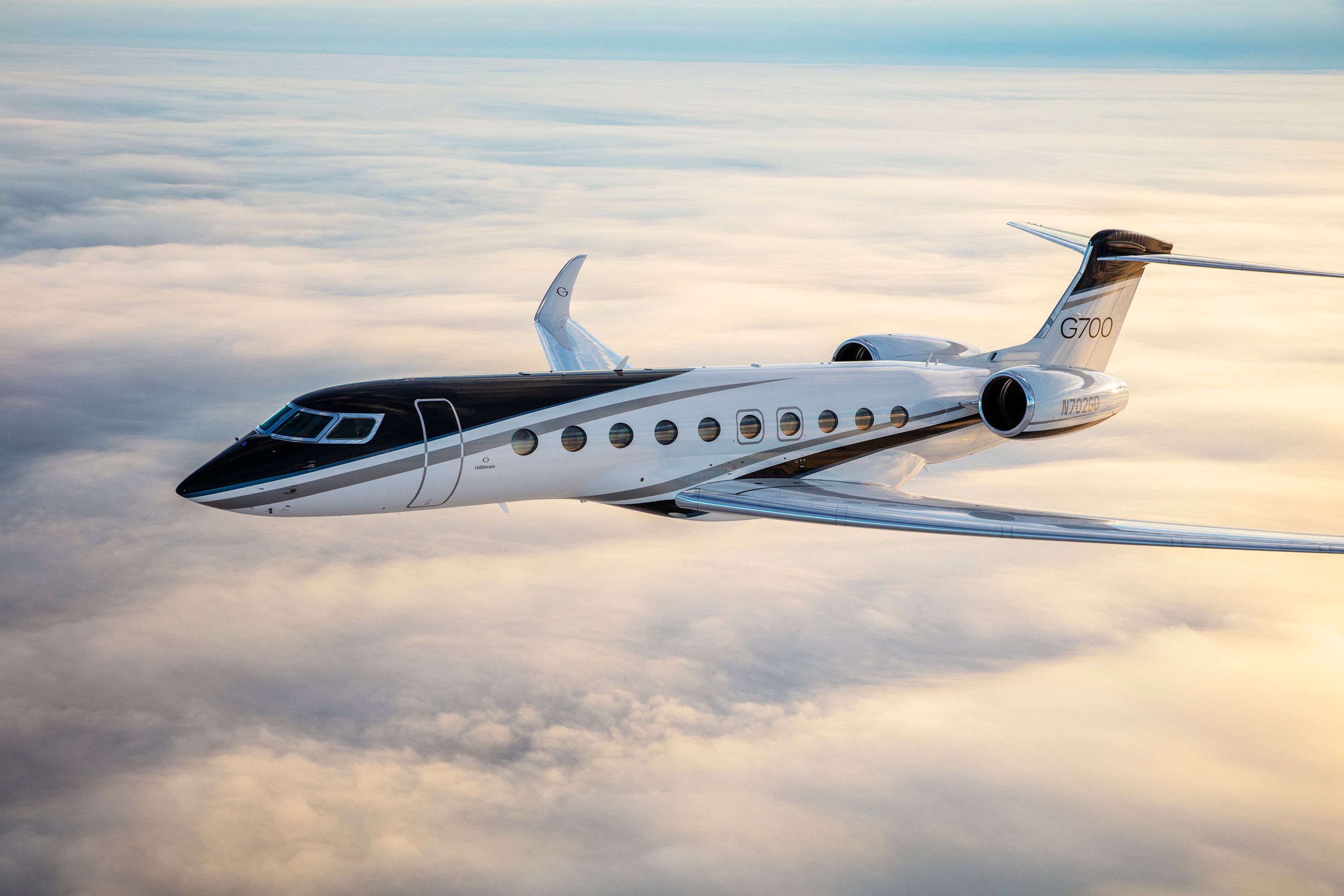 A Gulfstream G700 flying above the clouds.