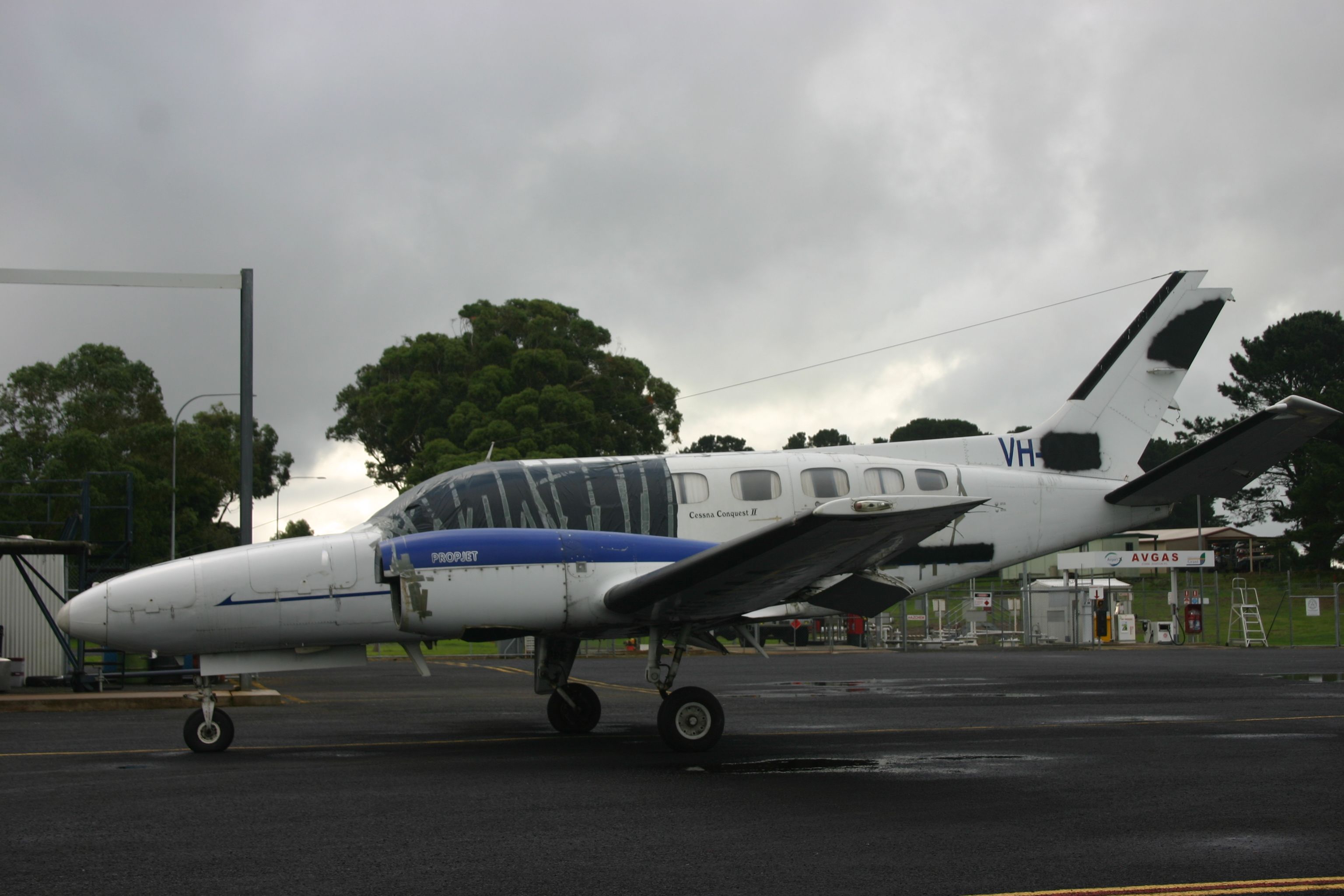 An Australian Cessna 441 Conquest II parked and stored at an airport.