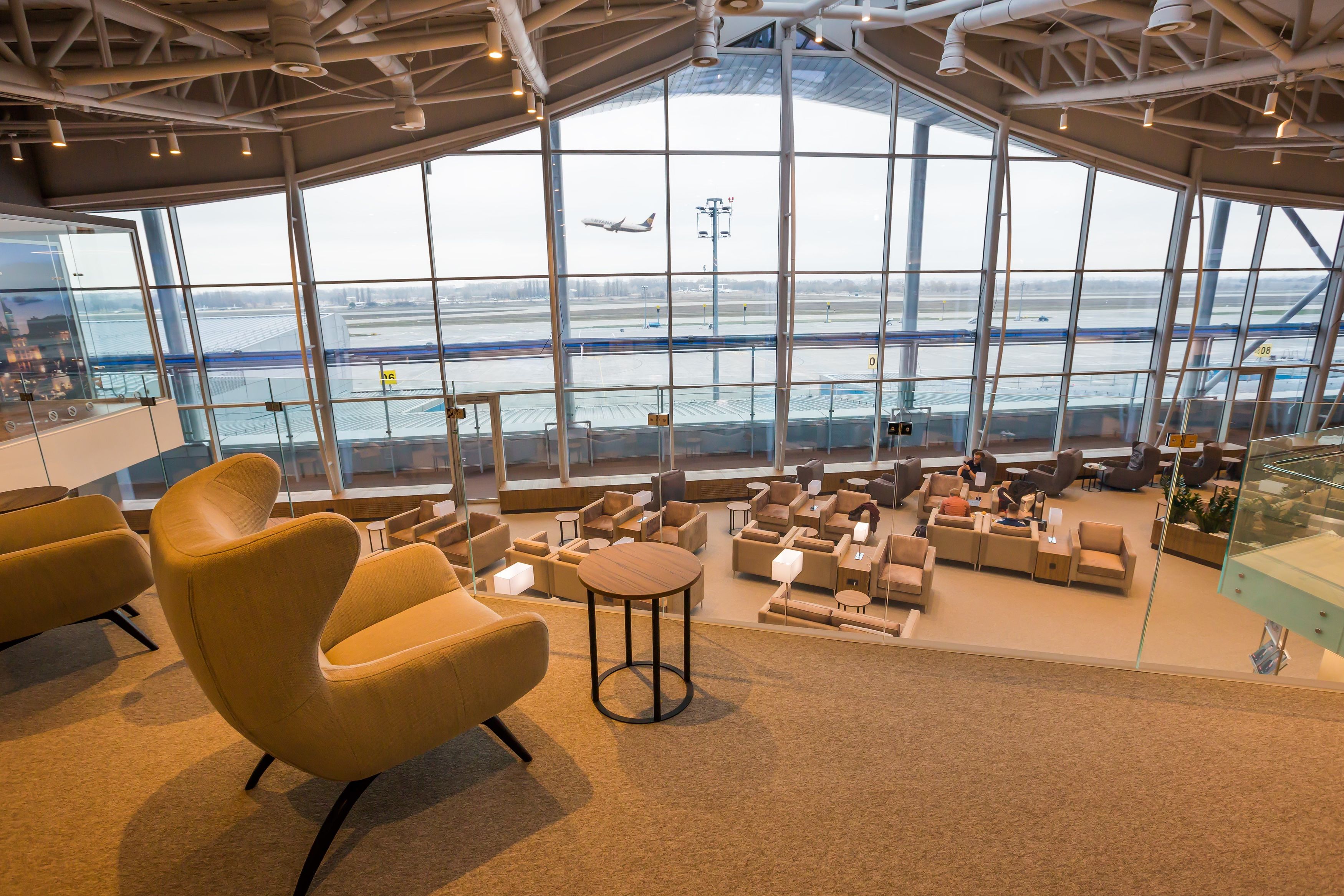 Inside a large airport lounge with incredible airport apron views.