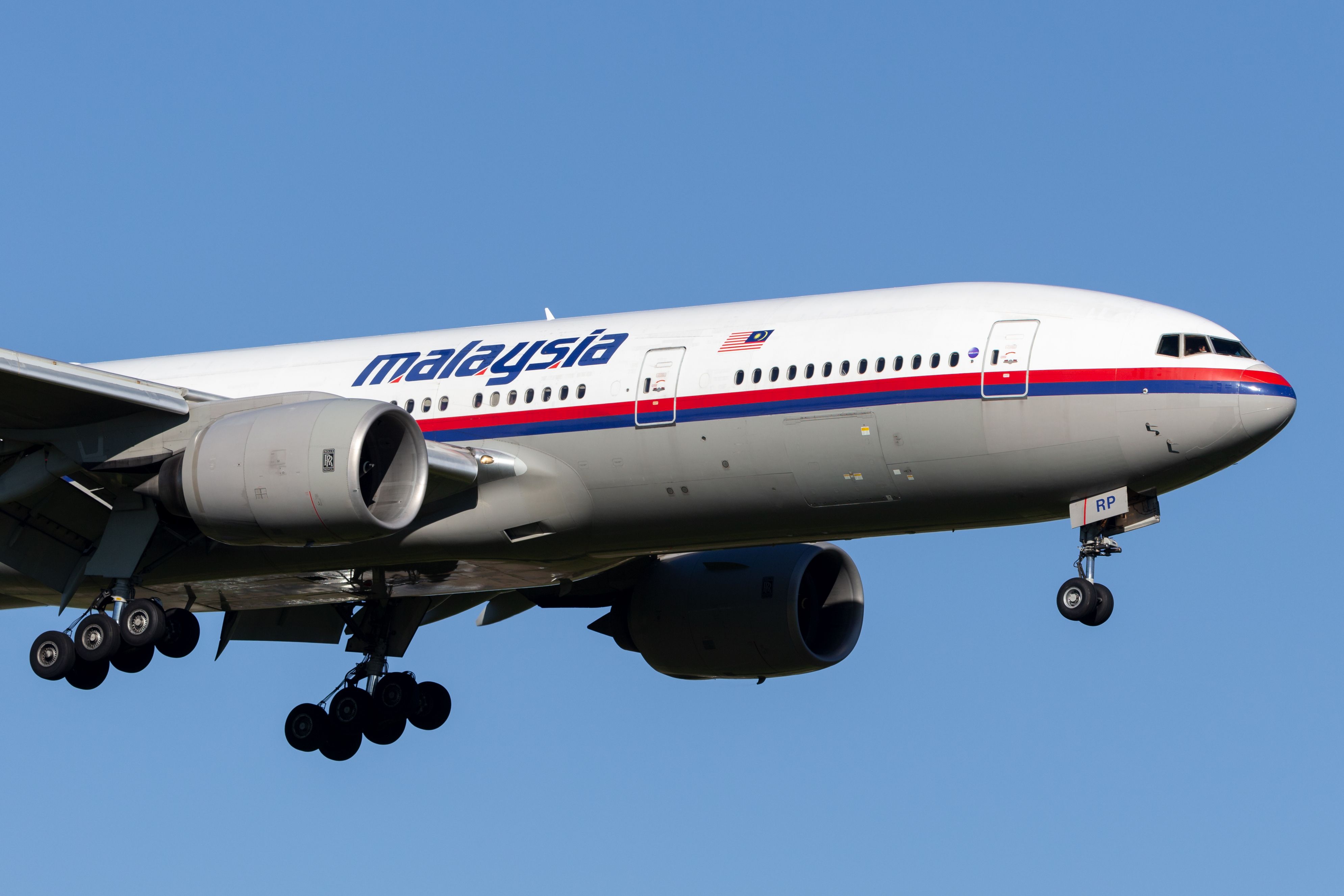 A Boeing 777-200ER of Malaysia Airlines flies in the sky.