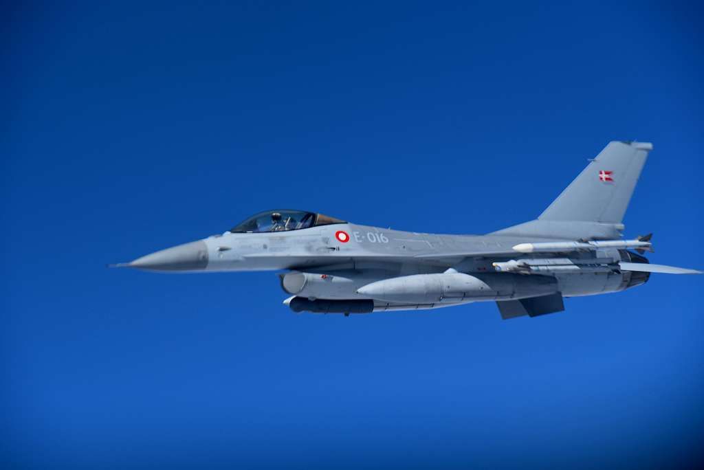 A Royal Danish Air Force F-16C flying in the sky.