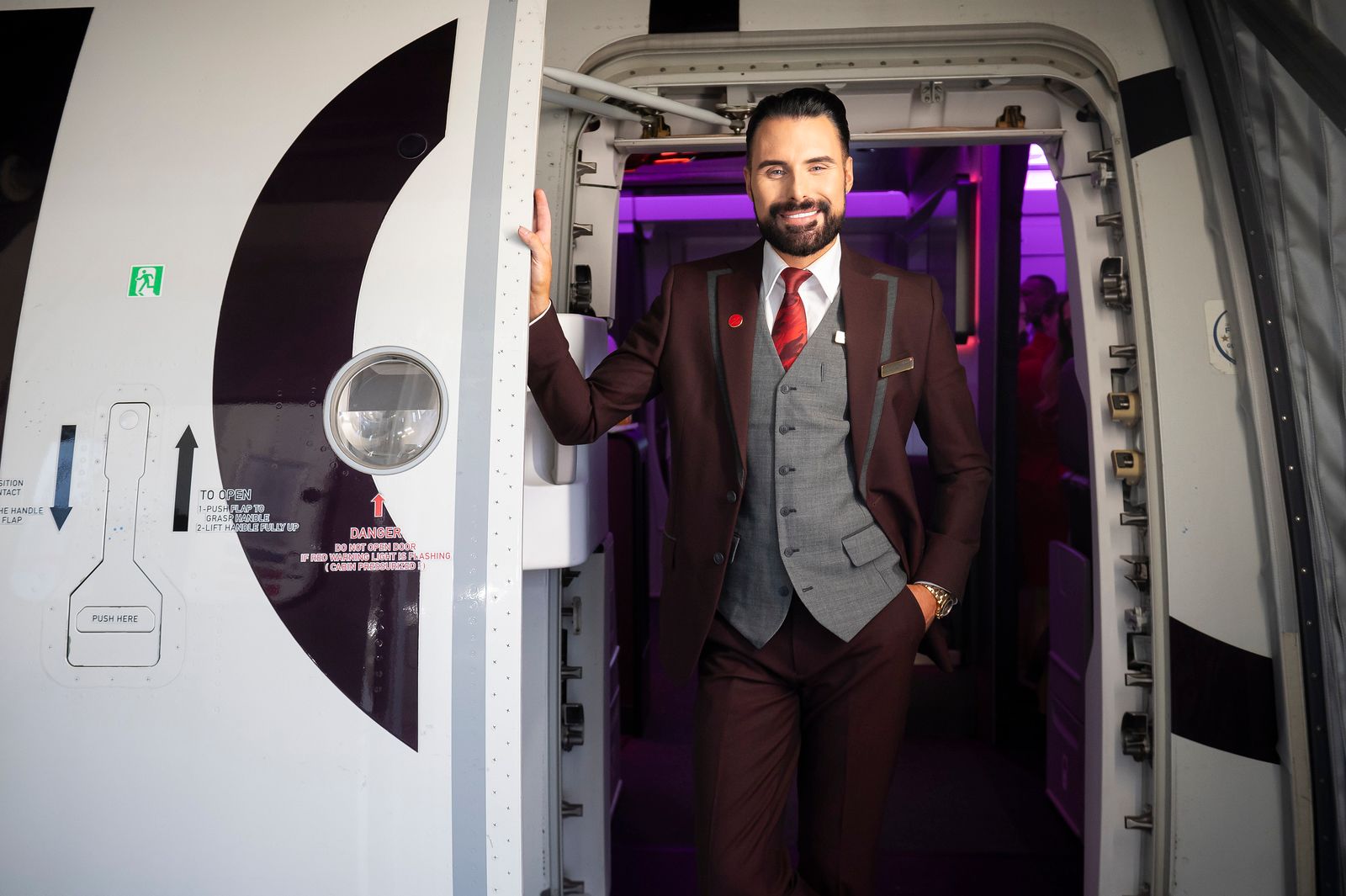 Rylan Clark welcoming passengers onboard a Virgin Atlantic flight