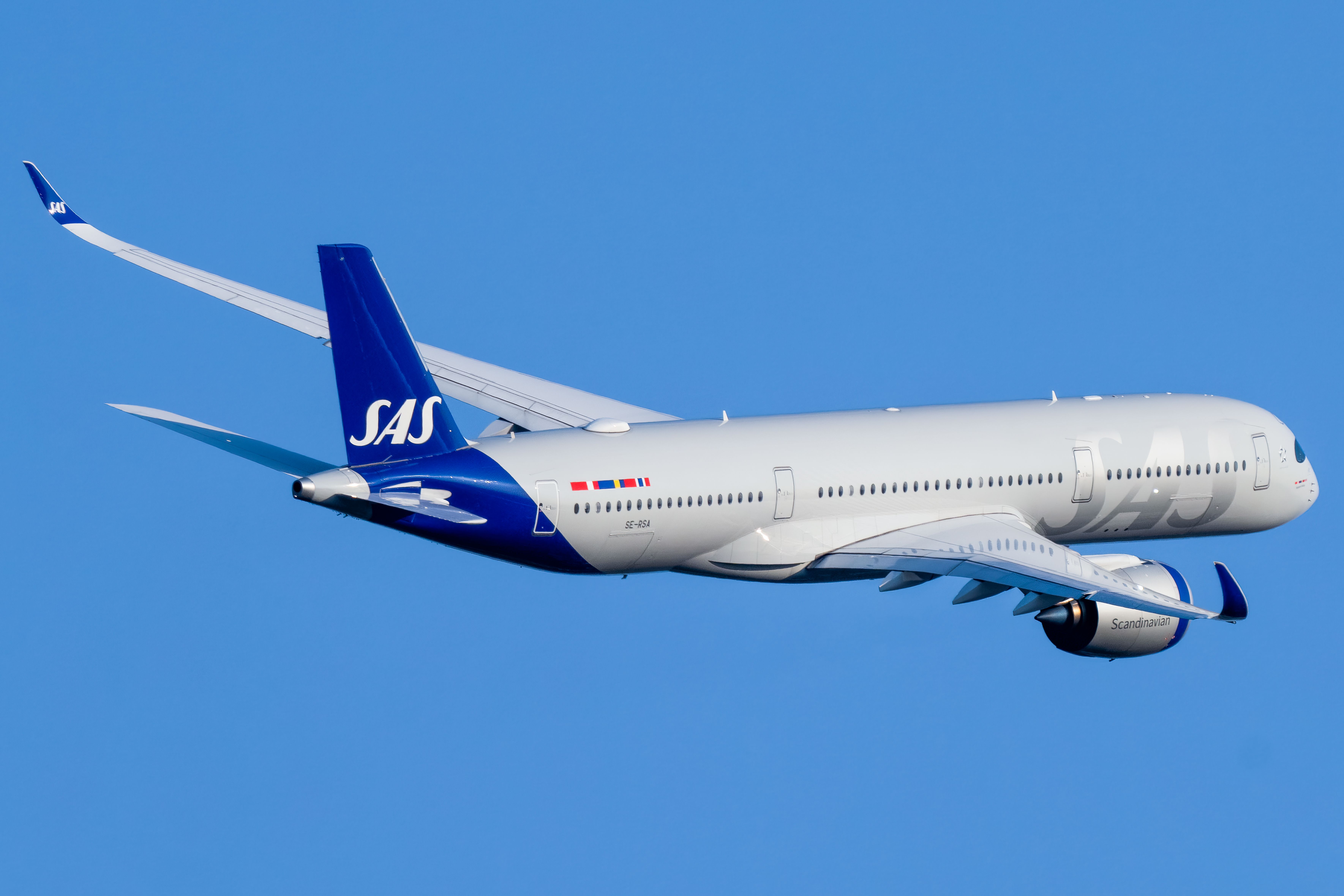 An SAS Airbus A350-900 flying in the sky.