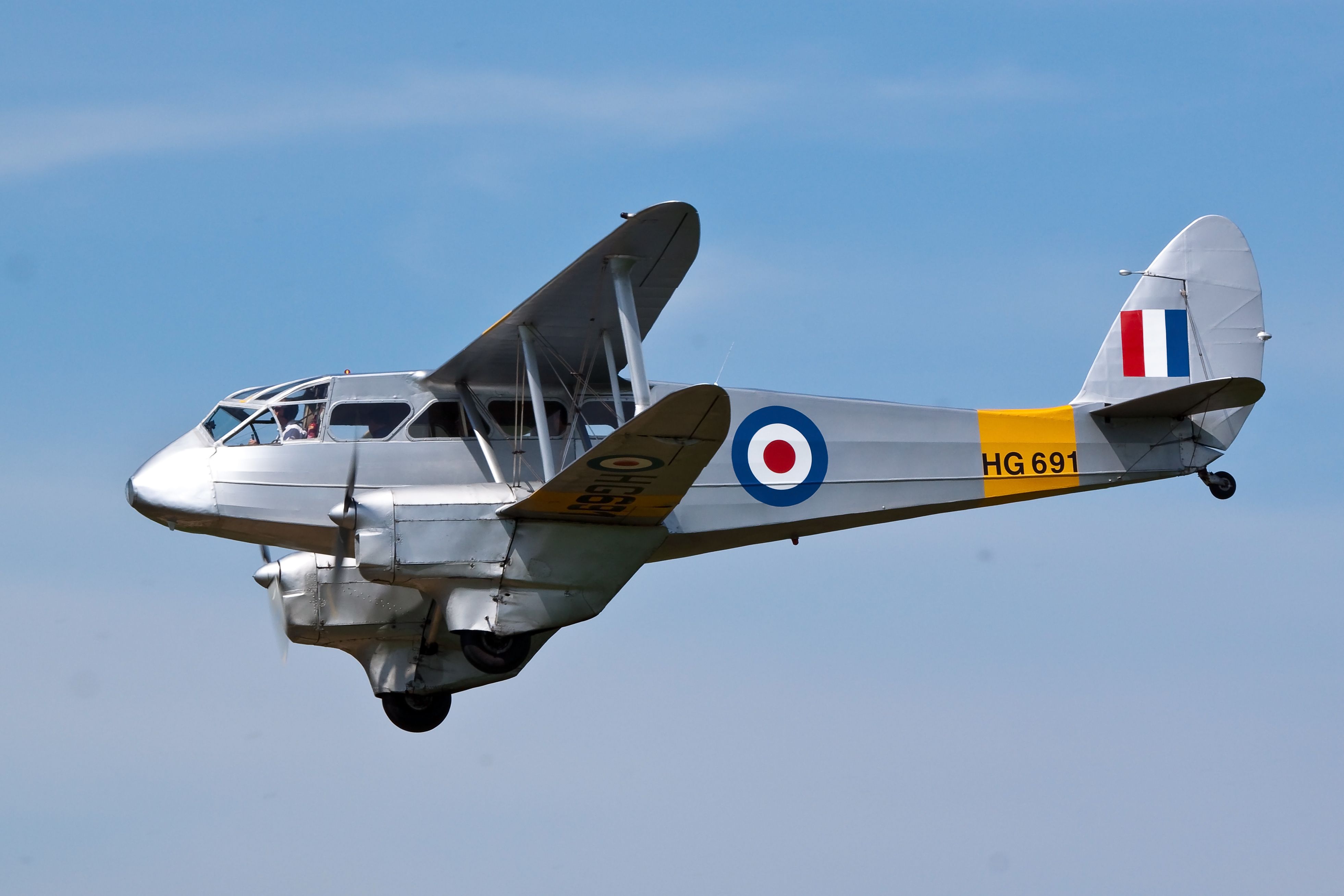 An RAF De Havilland Dragon Rapide Flying in the sky.