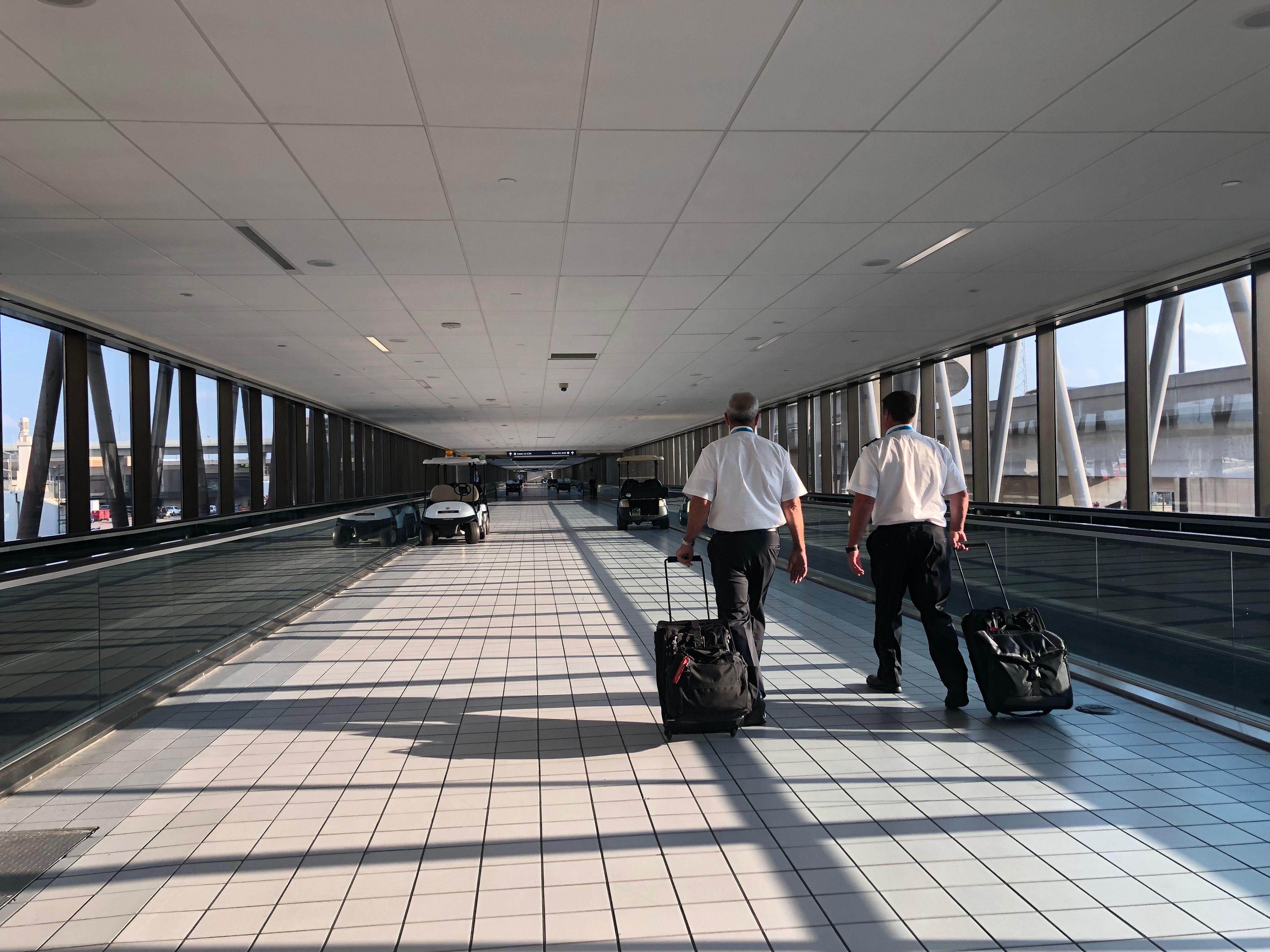 Pilots walking through the terminal connector at DFW airport. 