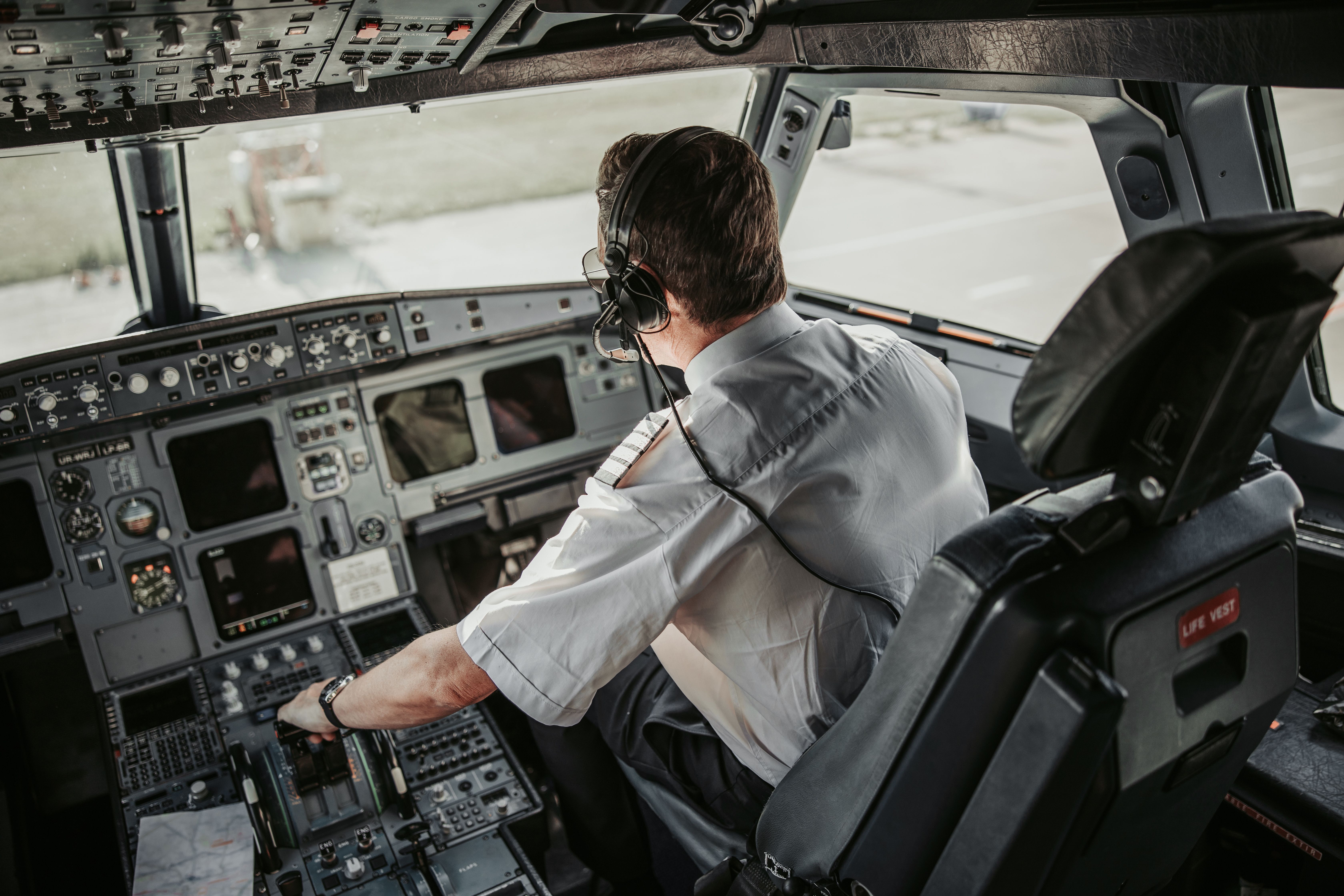 A pilot sitting in the cockpit of an aircraft.