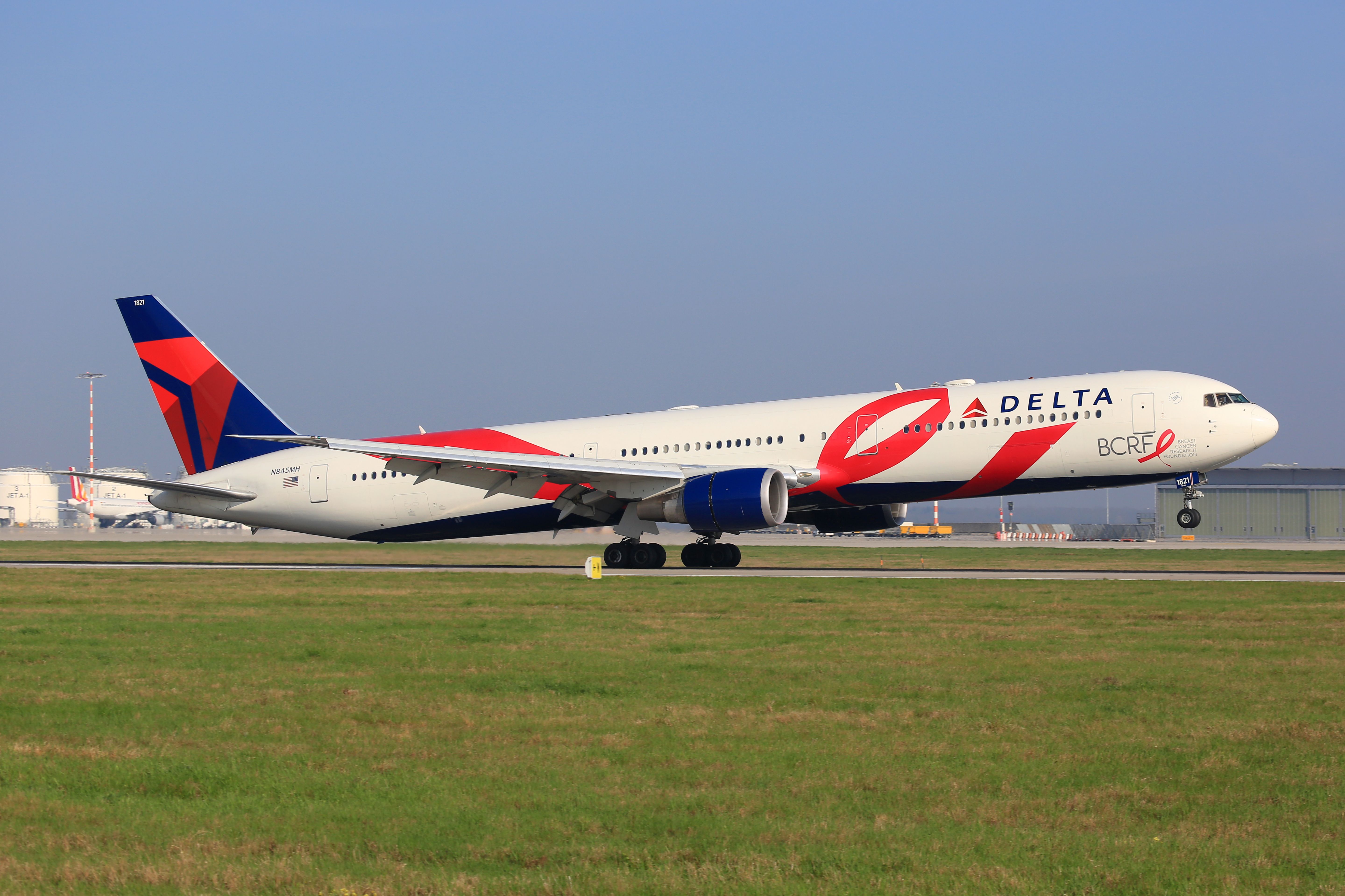 A Delta Air Lines Boeing 767-400ER in Breast Cancer Research Foundation livery taking off.