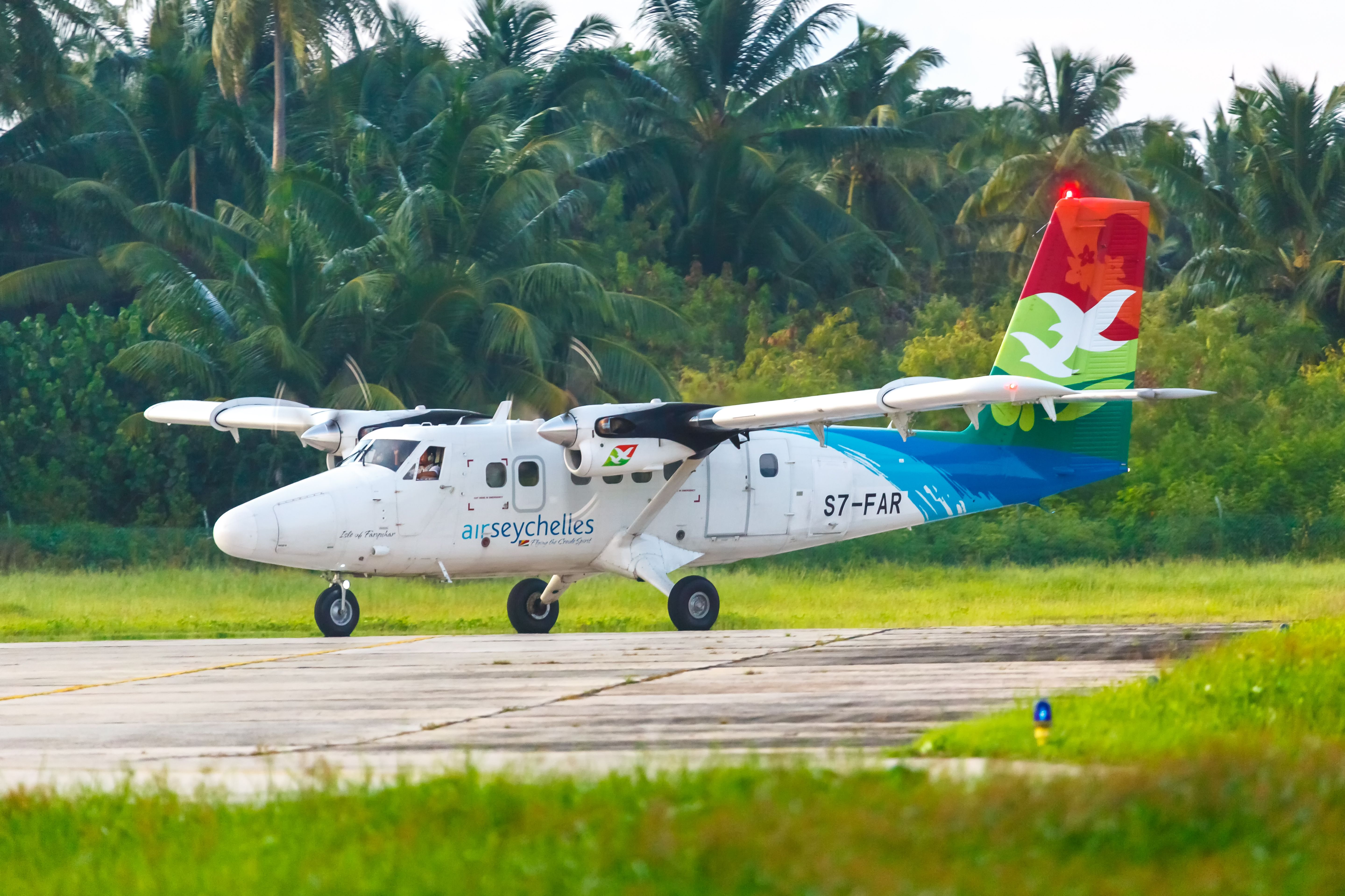 An Air Seychelles DHC-6-400 Twin Otter on an airport apron.
