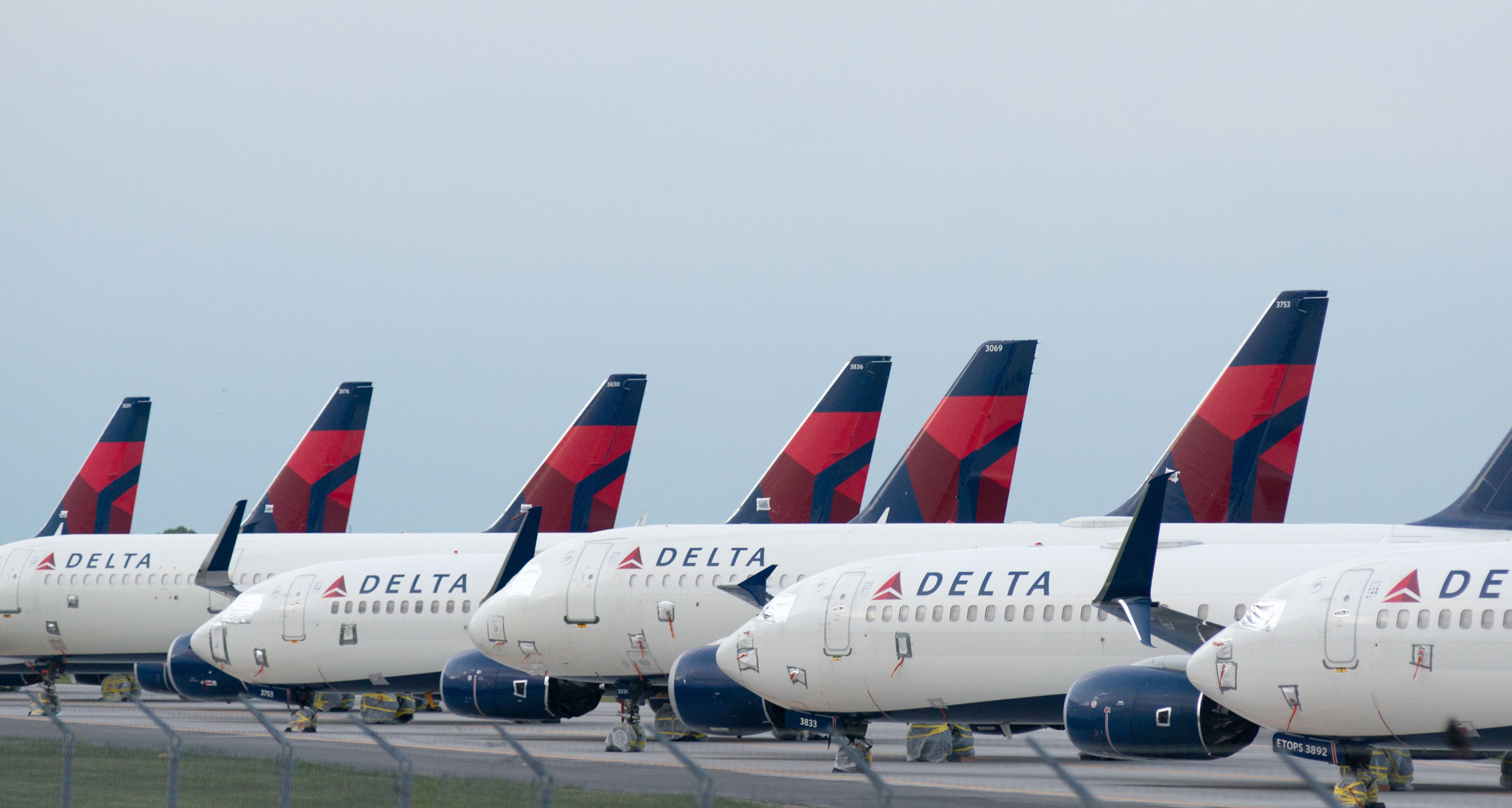 Many Delta Air Lines Boeing 737s Parked side by side.