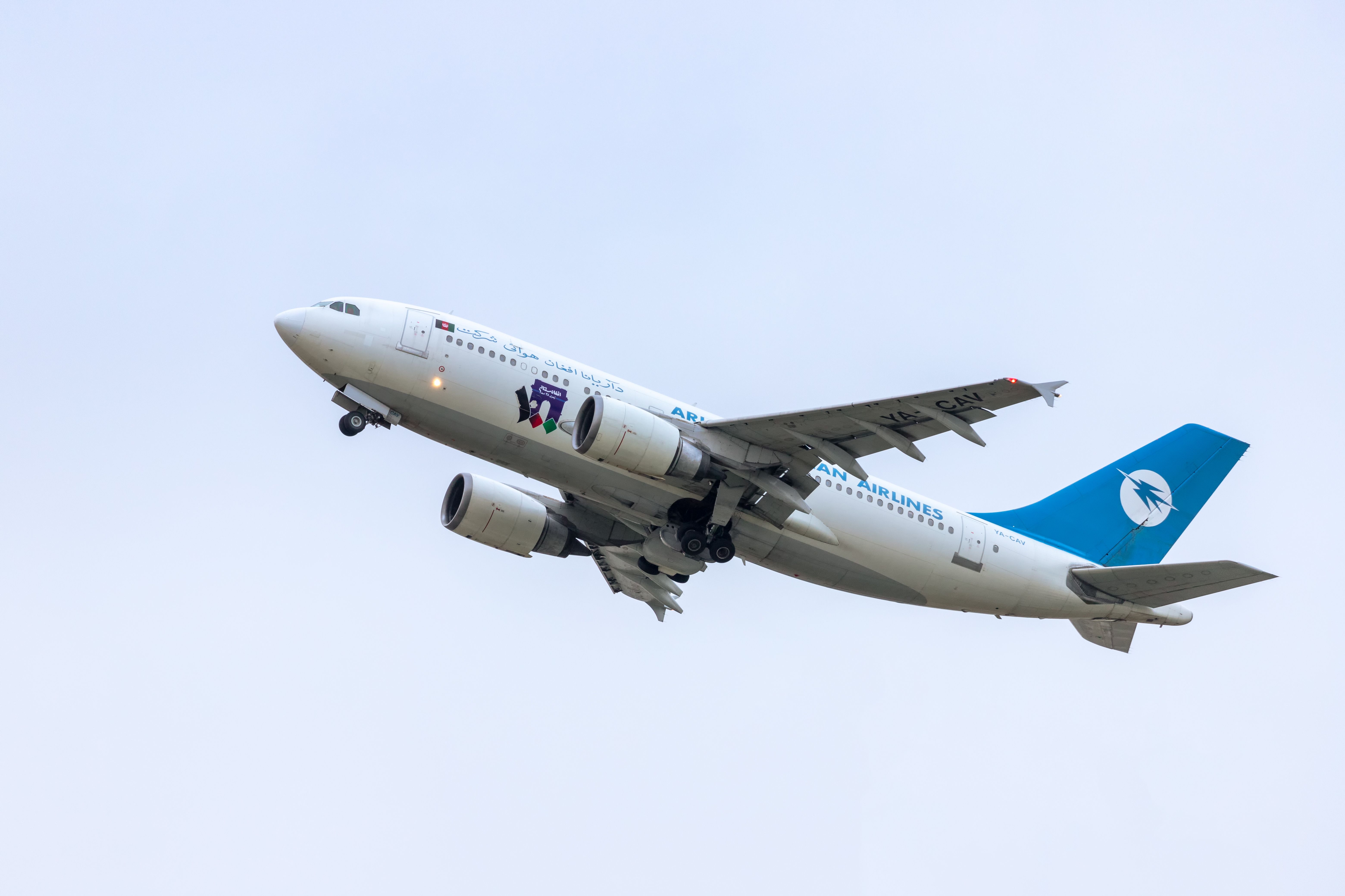 An Ariana Afghan Airlines Airbus A310-300 flying in the sky.