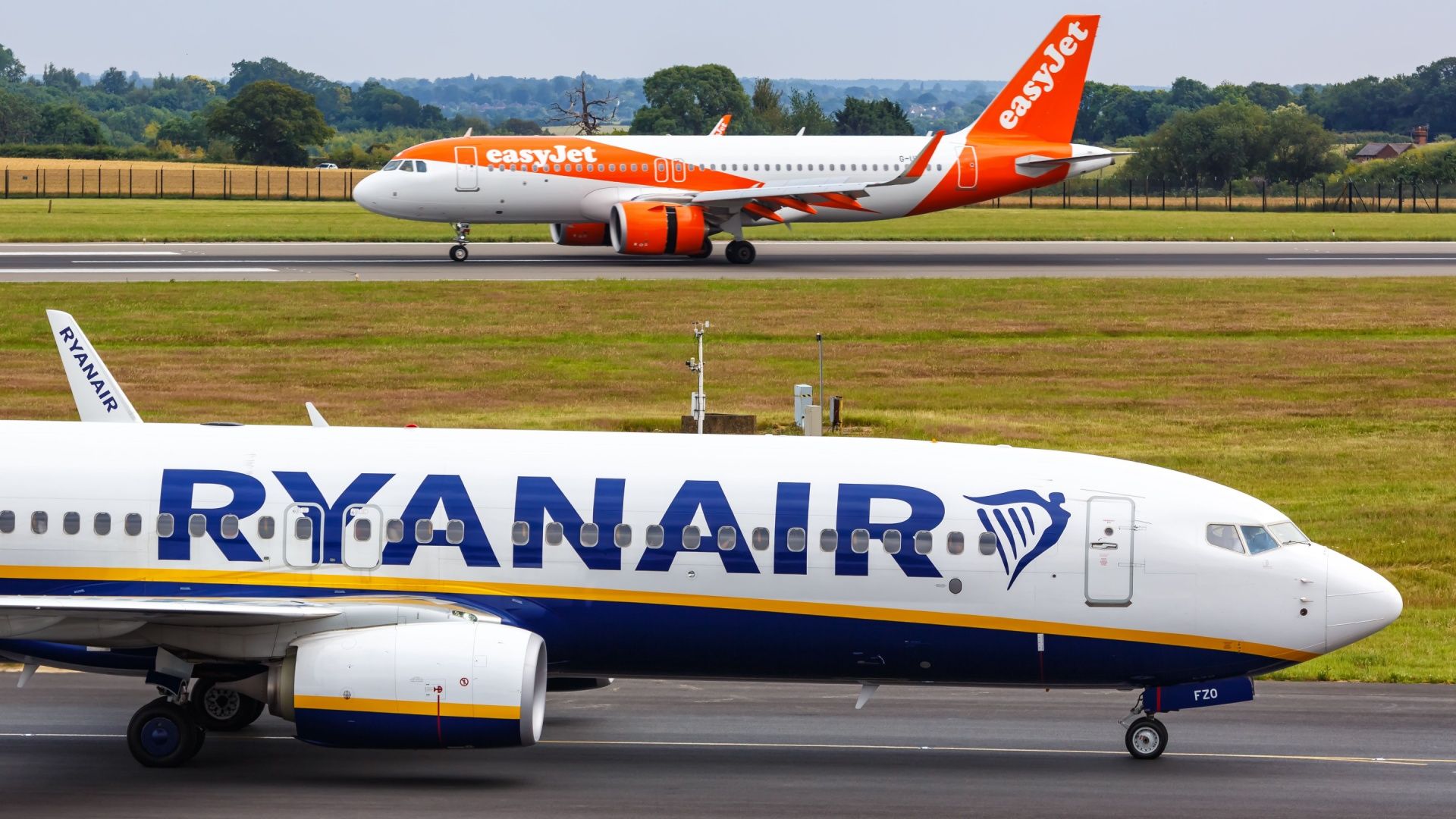 Ryanair and easyJet aircraft on an airport apron.
