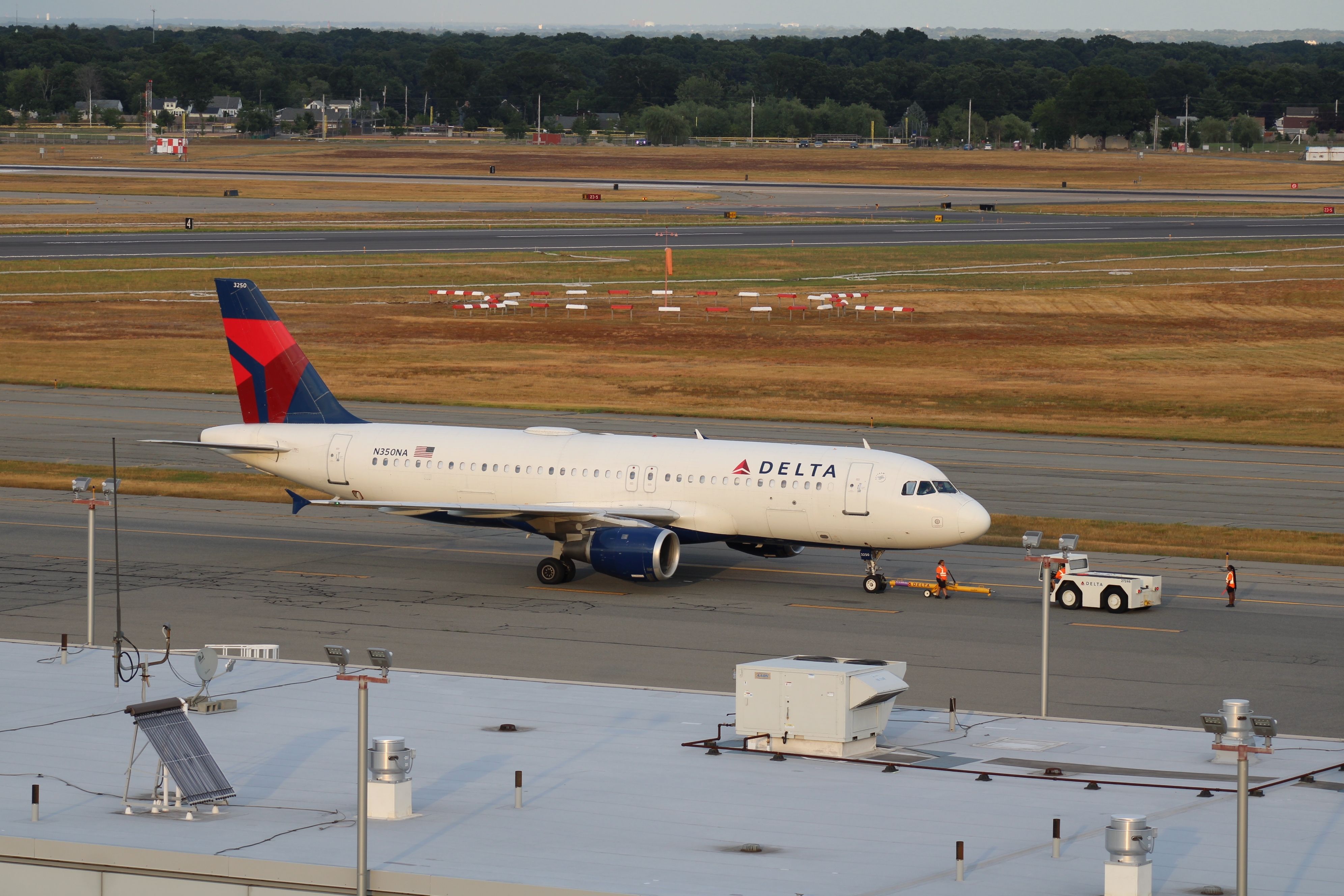 A Delta Air Lines Airbus A220-100 on an airport apron.