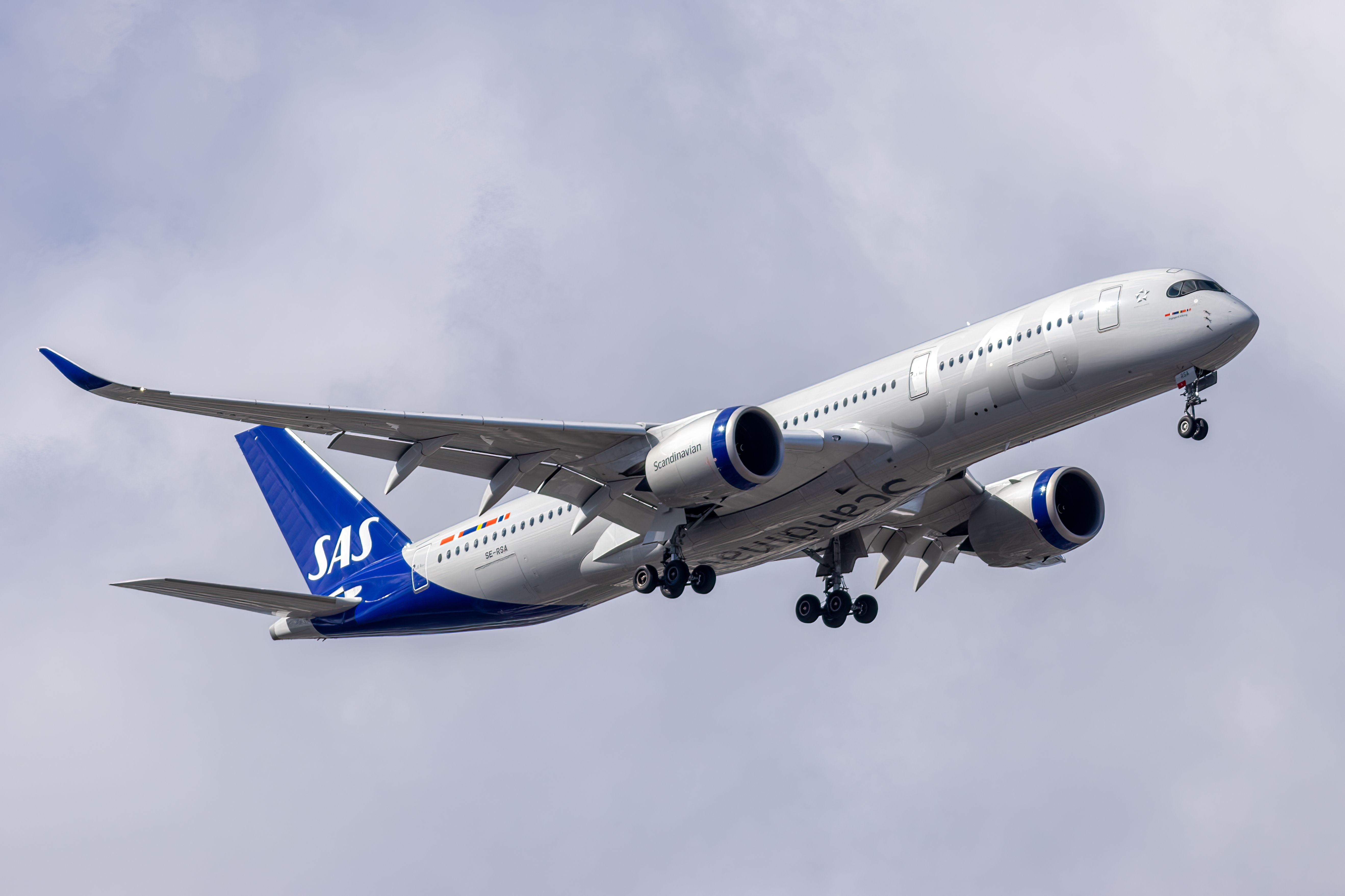 An SAS Airbus A350 flying in the sky.