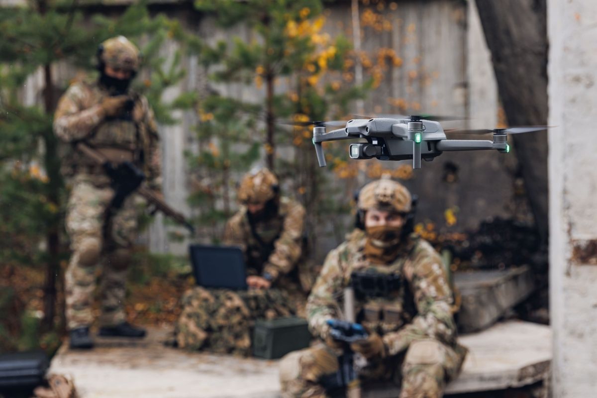 Military soldier controls drone for reconnaissance operation of enemy positions