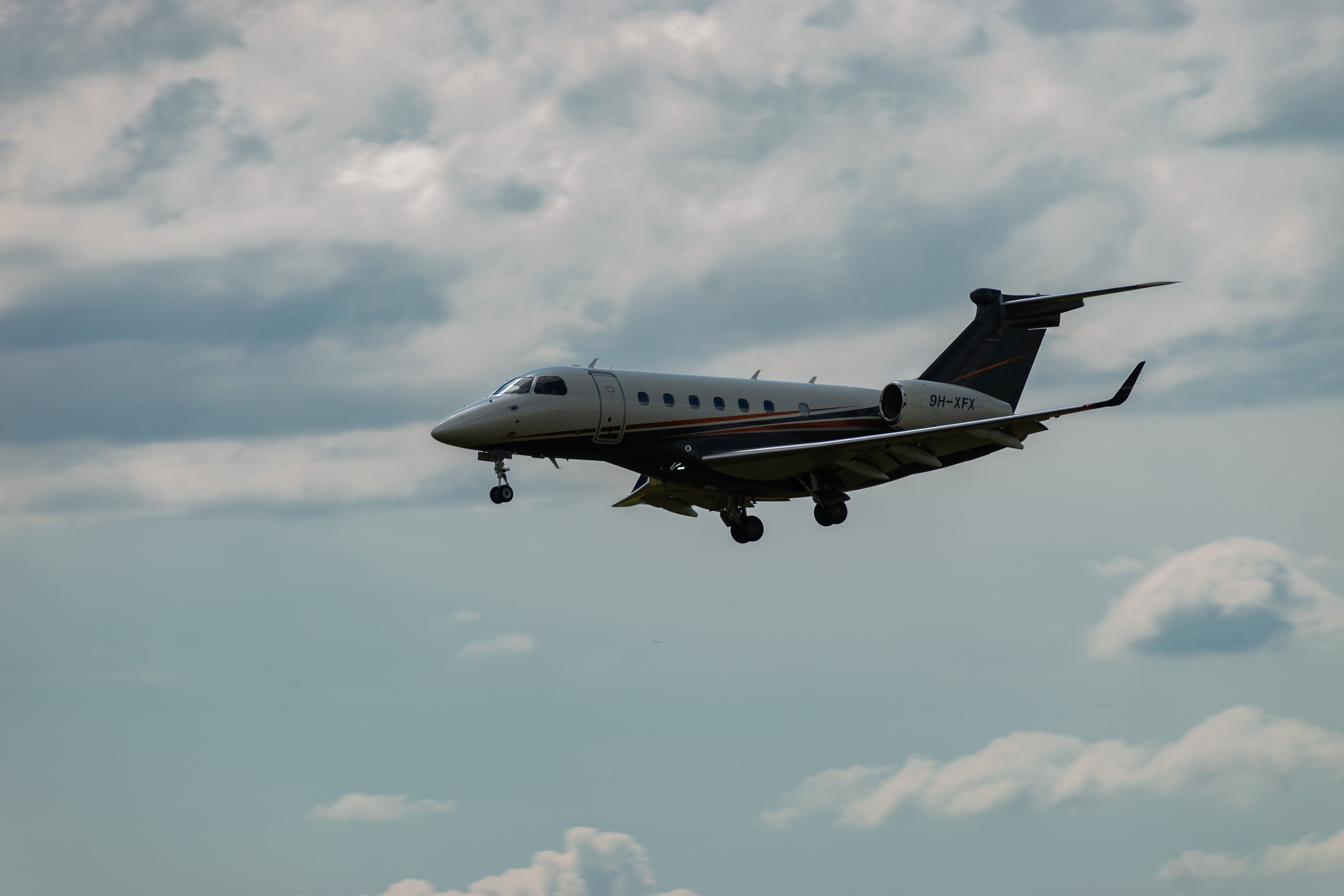 9H-XFX Embraer Legacy 500 aircraft is landing on runway 14