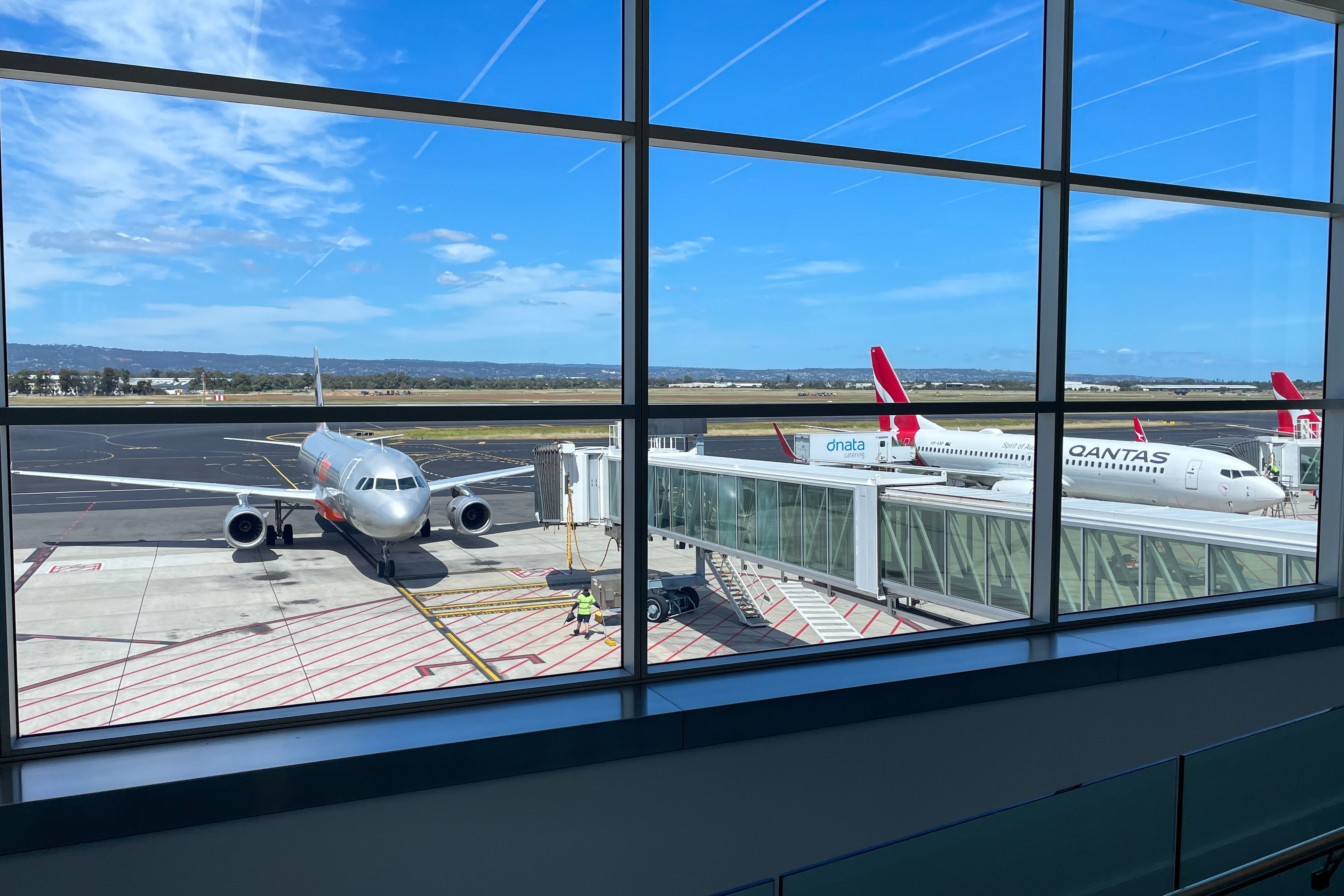 etstar and Qantas aircrafts parked at Adelaide Airport.