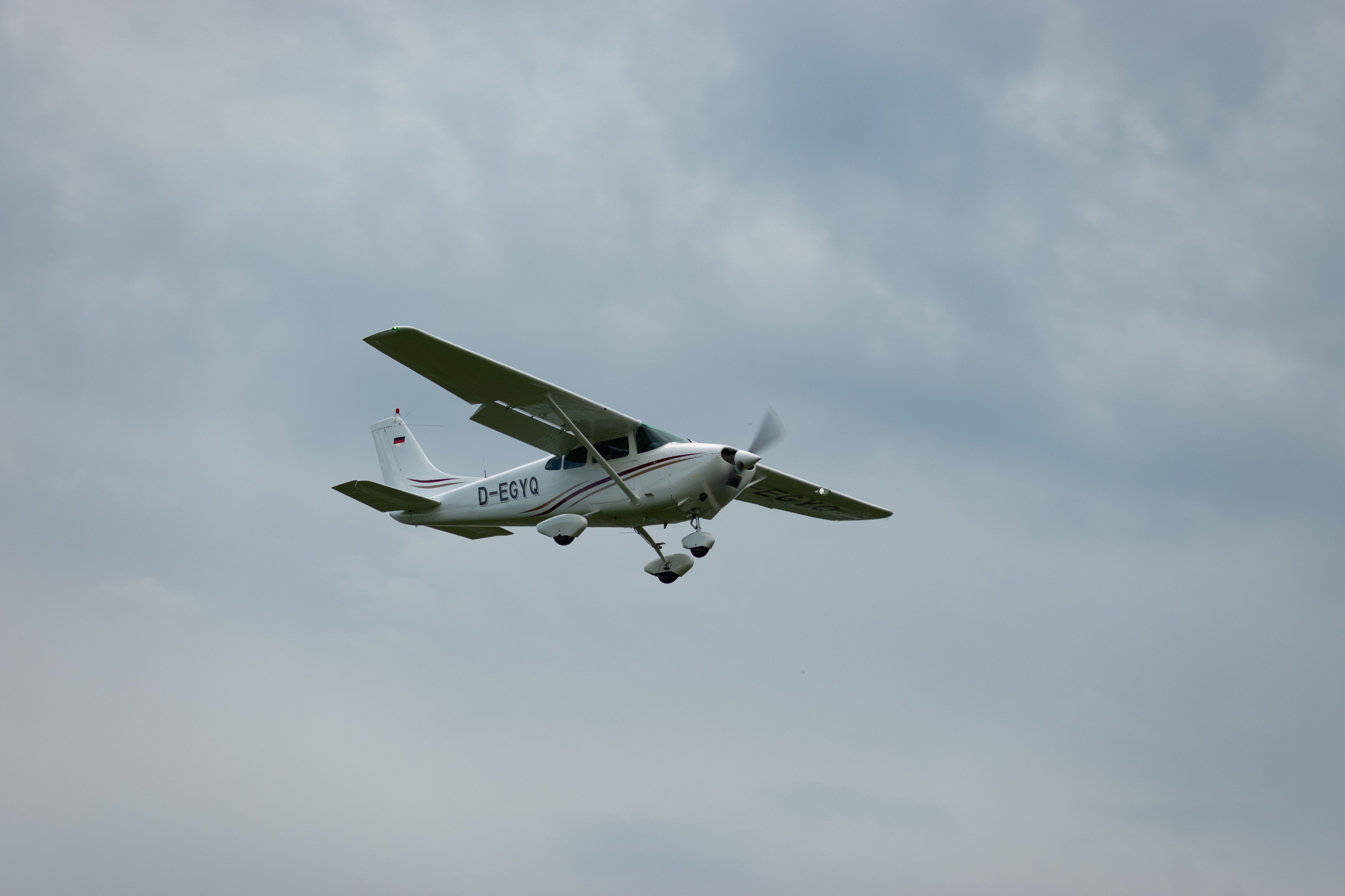 A Cessna 182 flying in the sky.