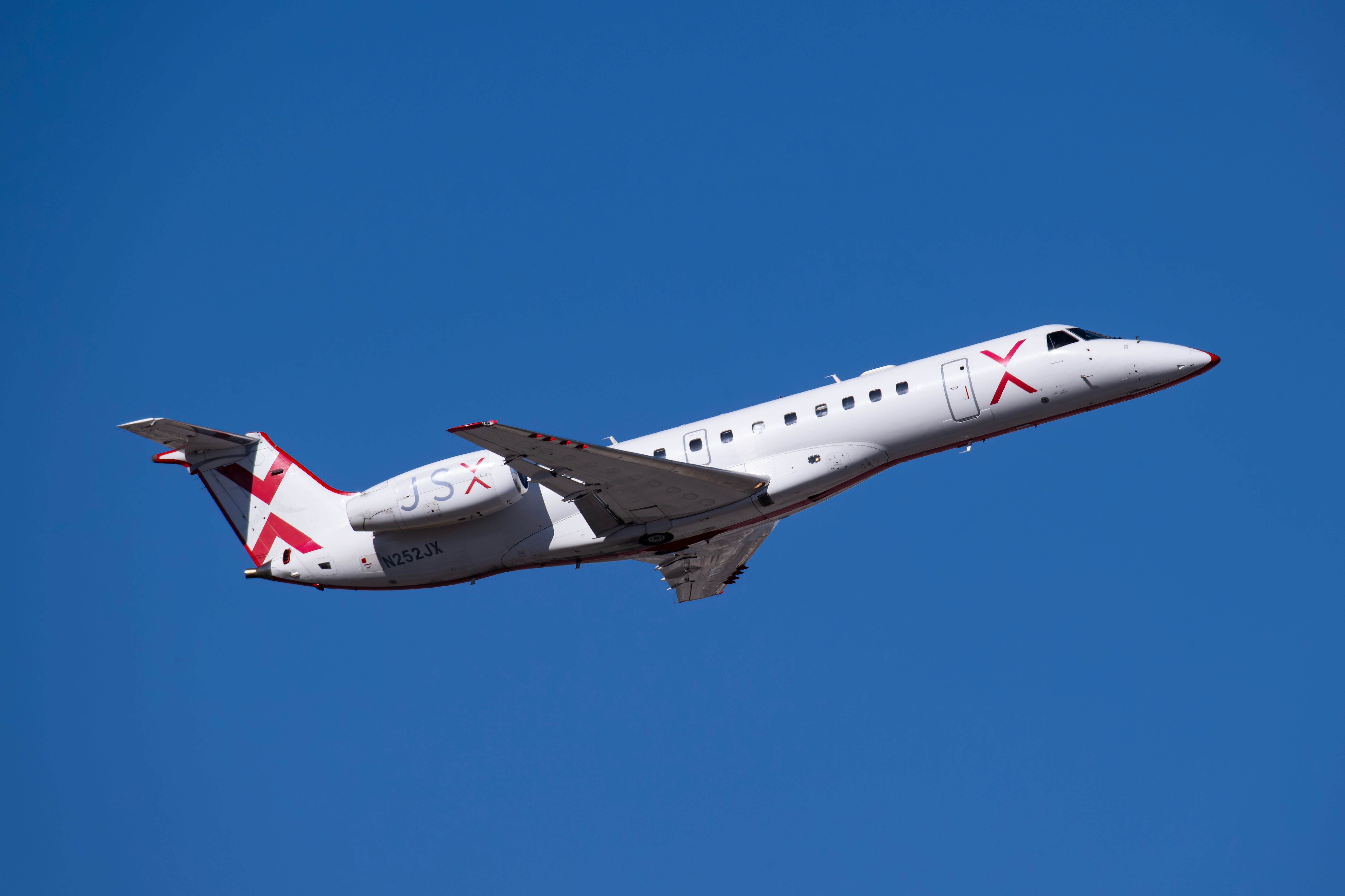 JSX Embraer ERJ-135 taking off.