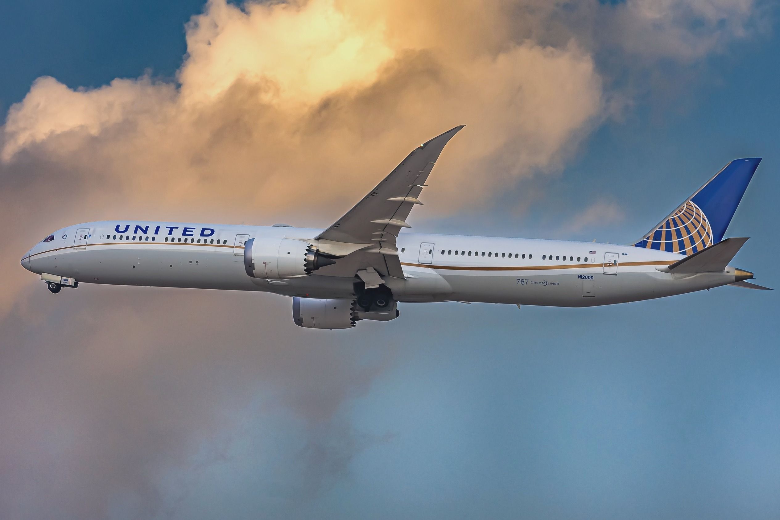 A United Airlines Boeing 787-10 Dreamliner flying in the sky.