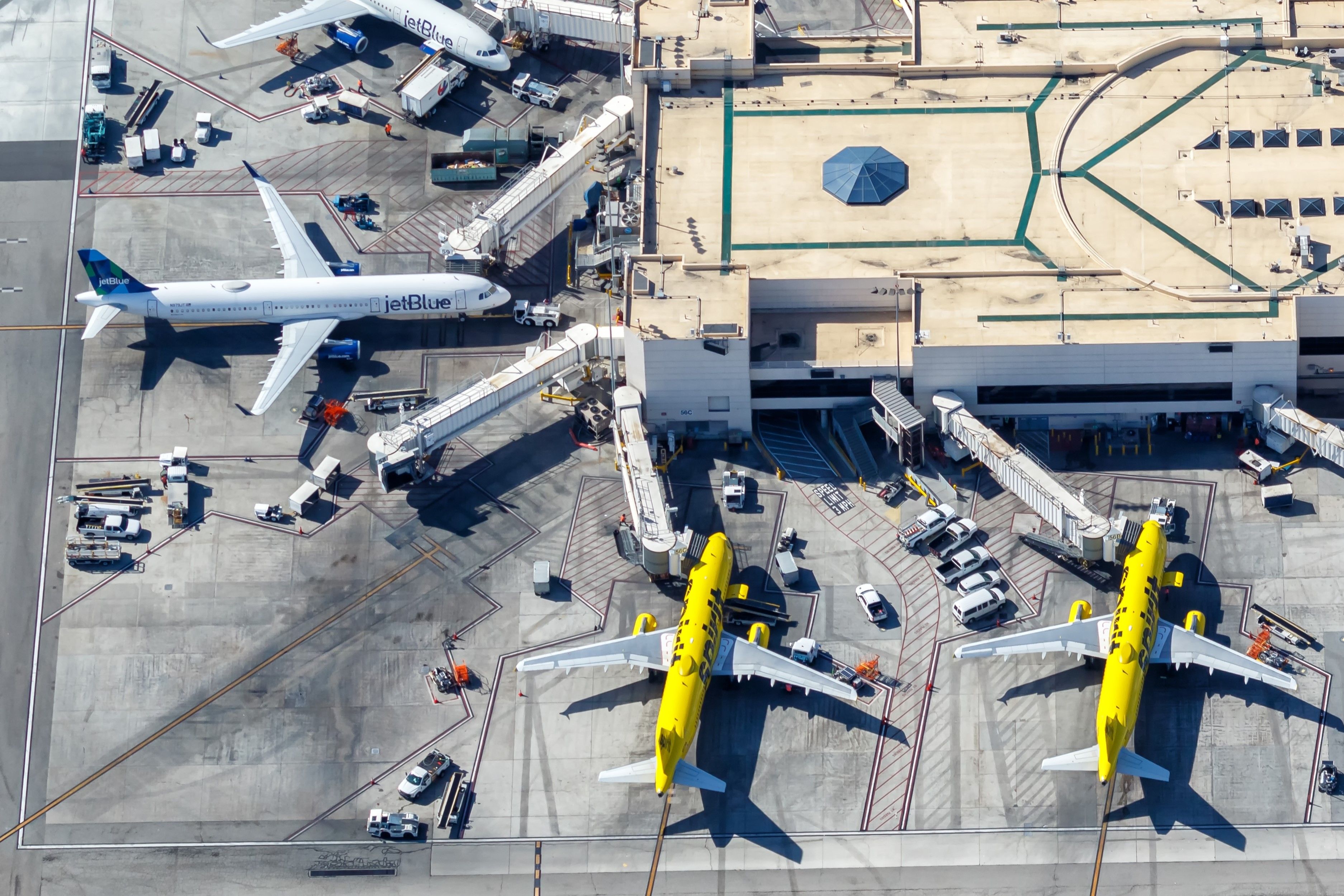shutterstock_2413840295 (4x6 crop) - Los Angeles, United States - November 4, 2022: Airplanes from jetBlue and Spirit Airlines at Los Angeles Airport (LAX) aerial view in the United States.