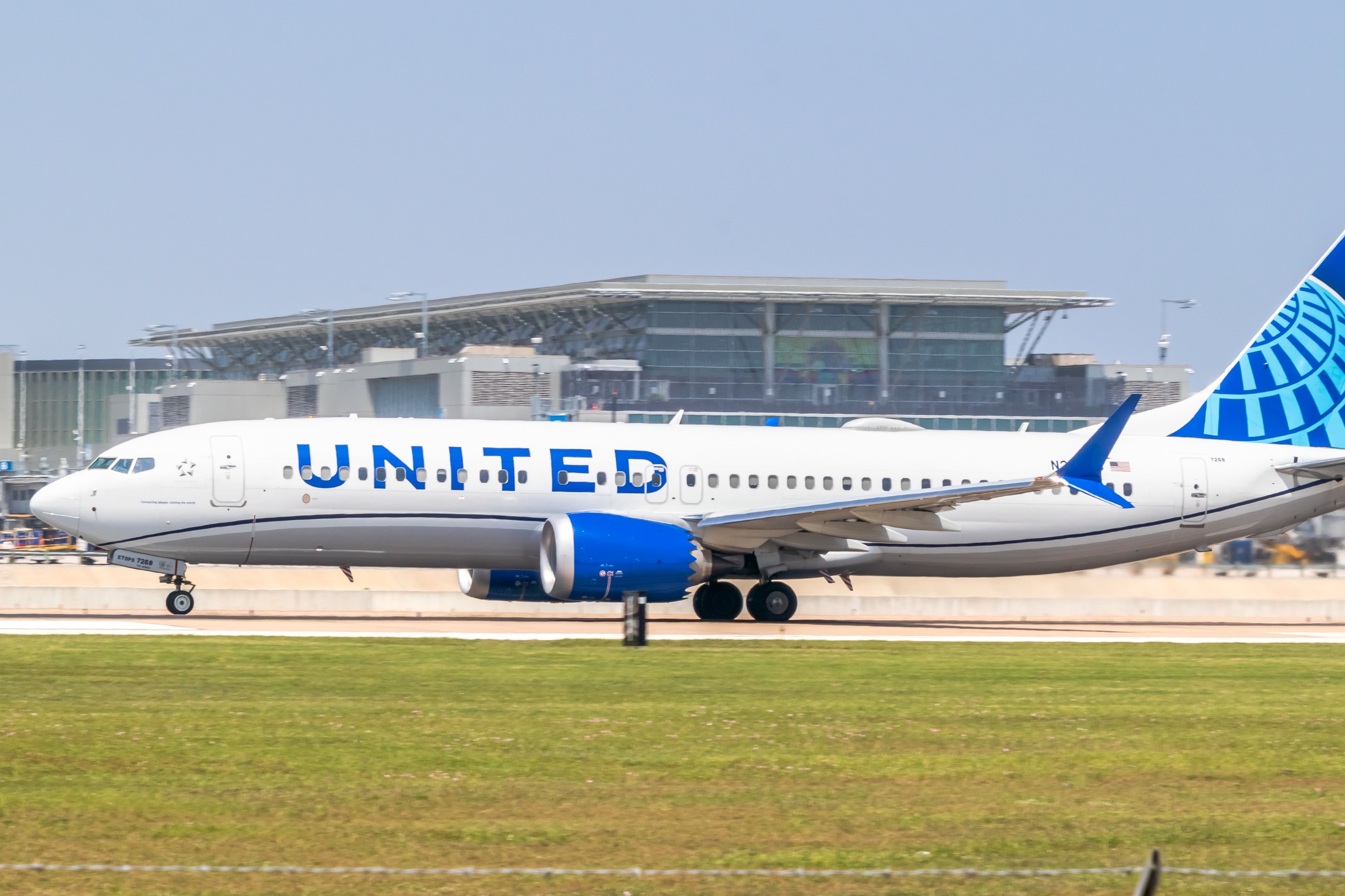 A United Airlines Boeing 737 MAX 8 on an airport apron.